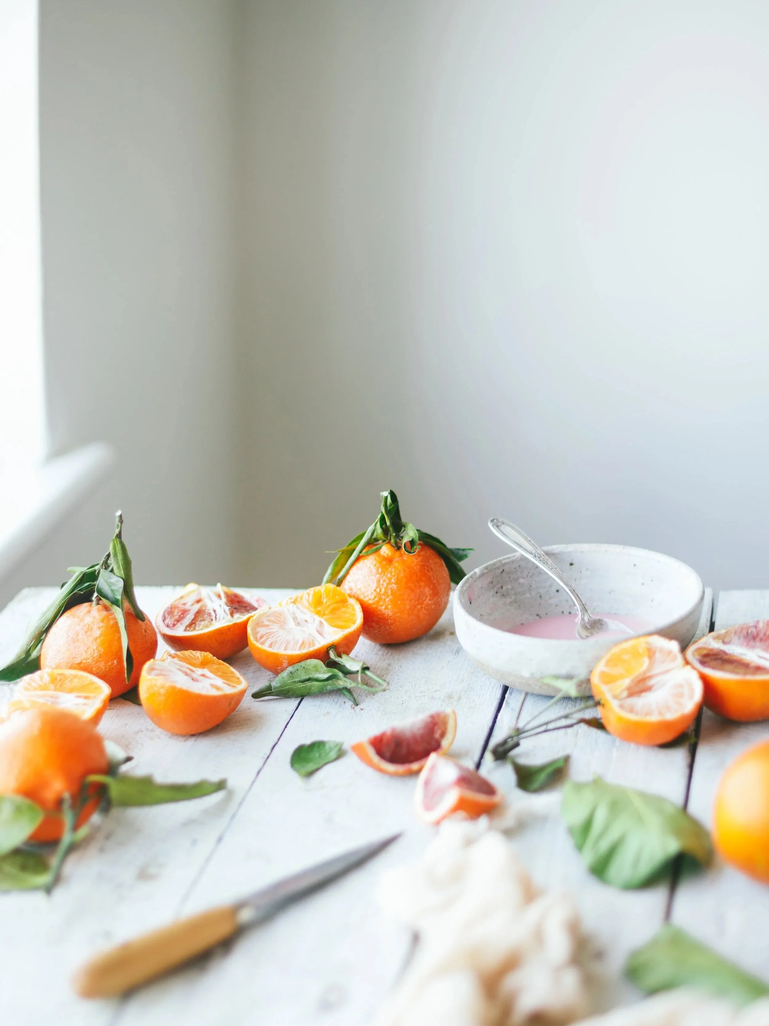 Course bundle image showing some halved citrus fruit on a white wooden surface