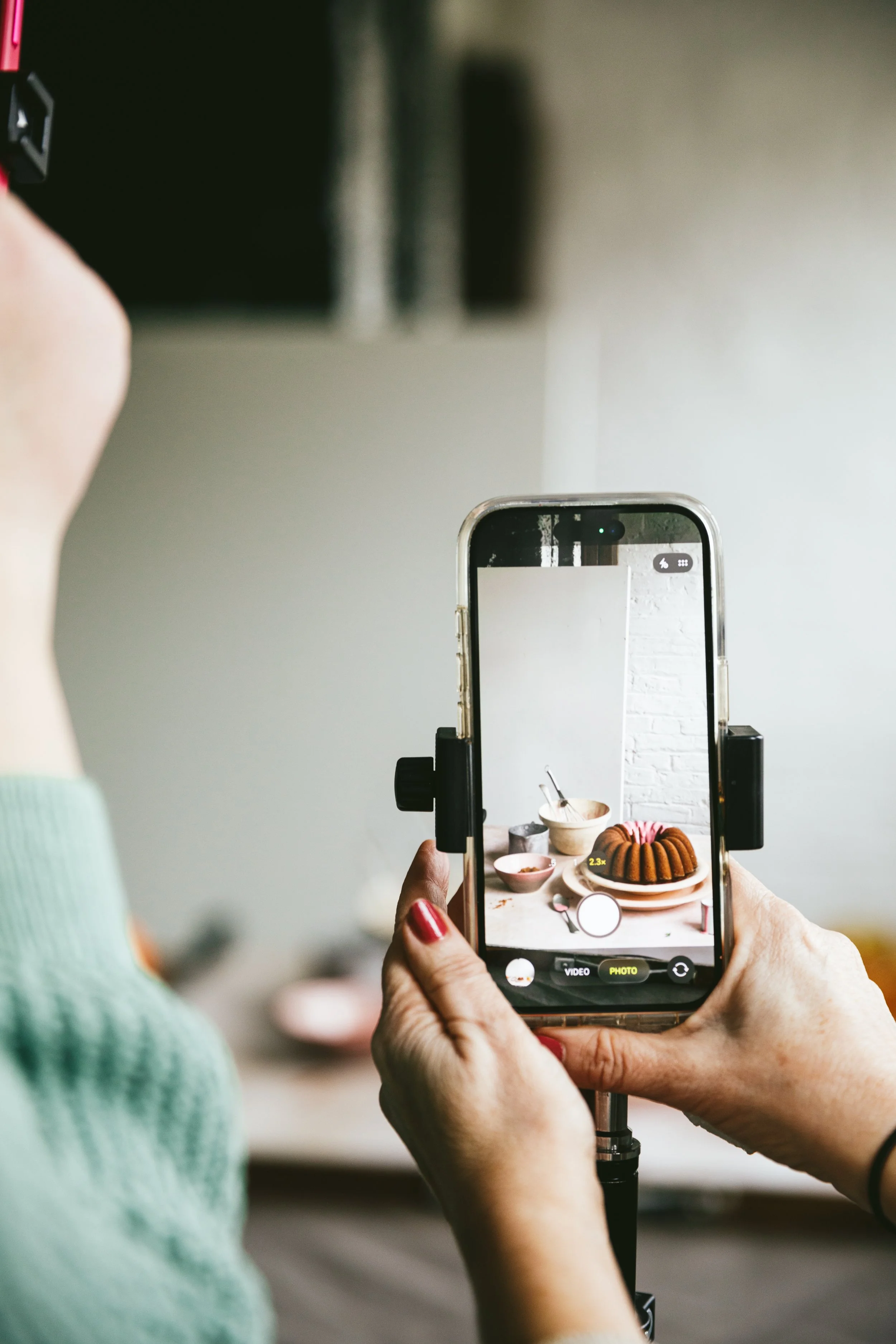 Blog post image showing a cake scene through the screen of a mobile phone