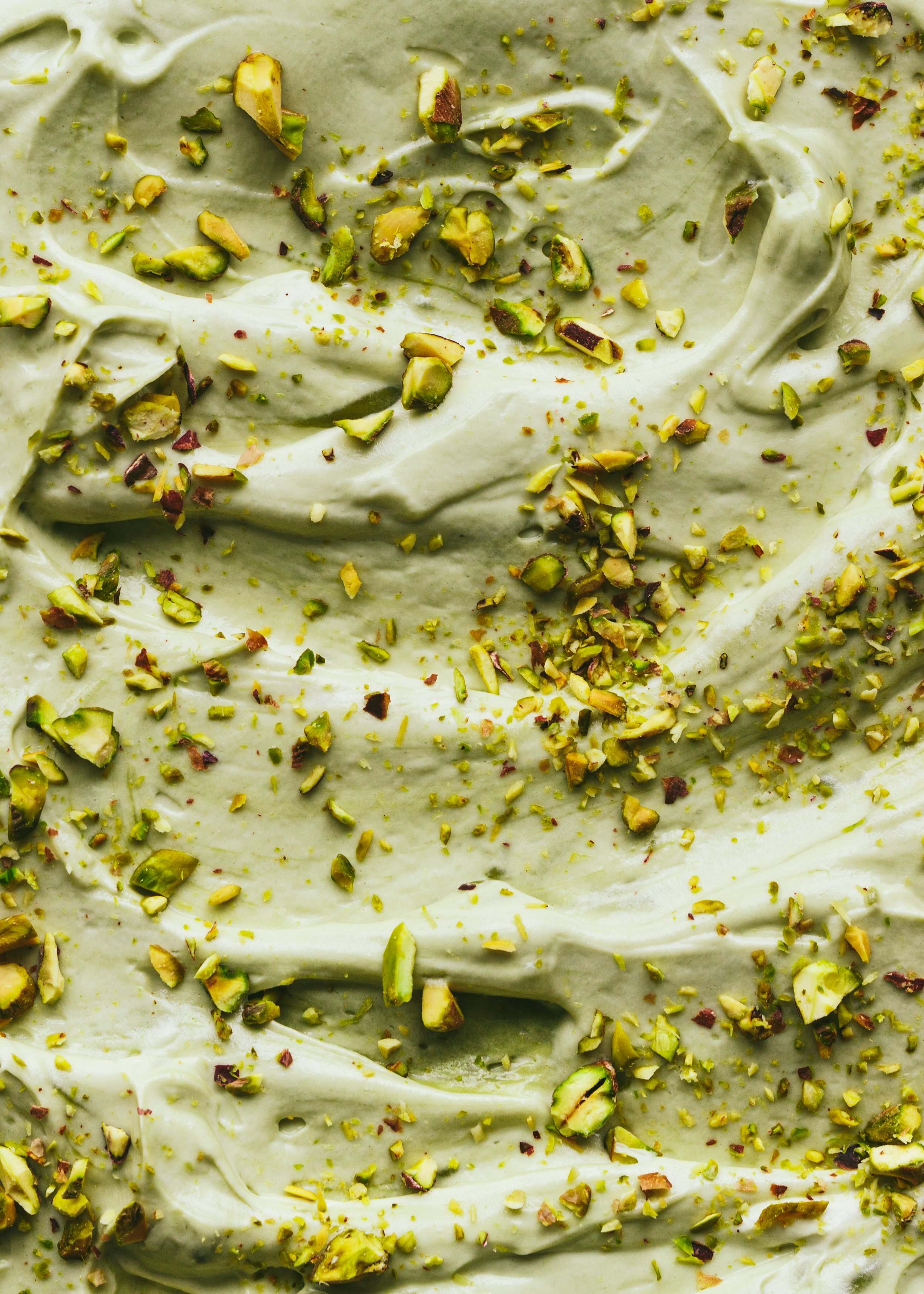 Kimberly Espinel portfolio image showing a close up of cake frosting sprinkled with chopped pistachios