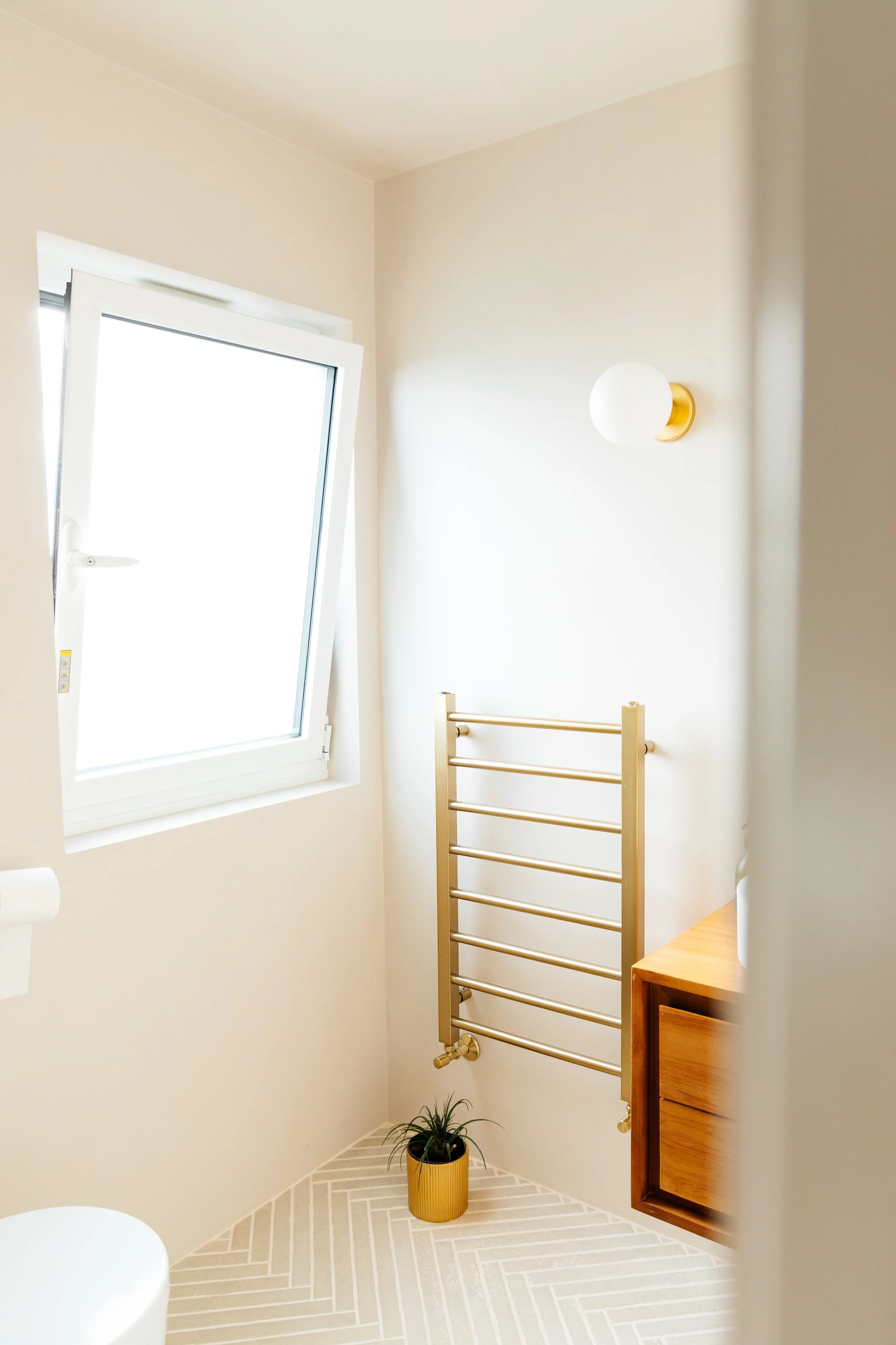 Blog post image showing a bright bathroom corner with a large window