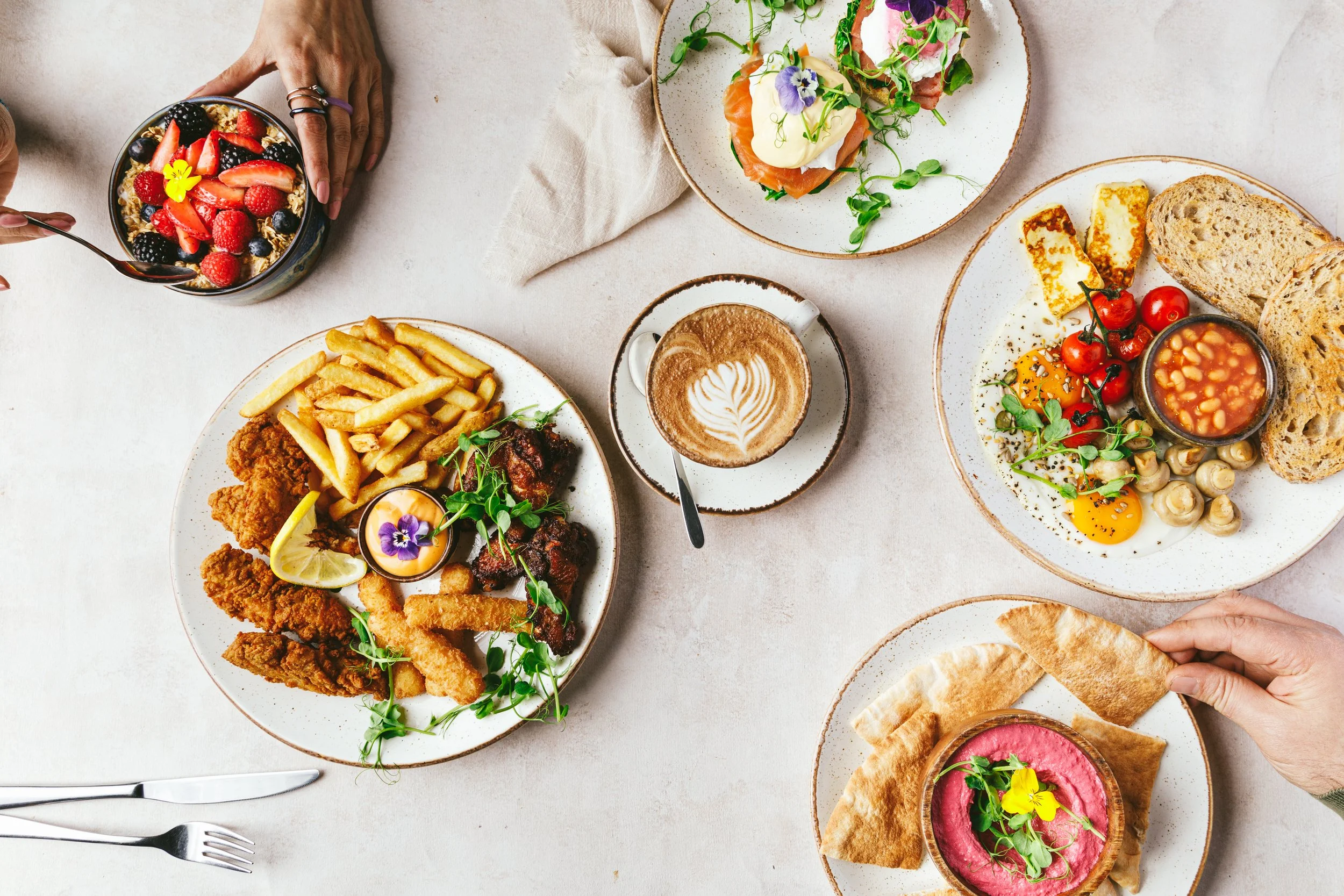Kimberly Espinel portfolio image showing a brunch style spread with various dishes and coffee on a bright background