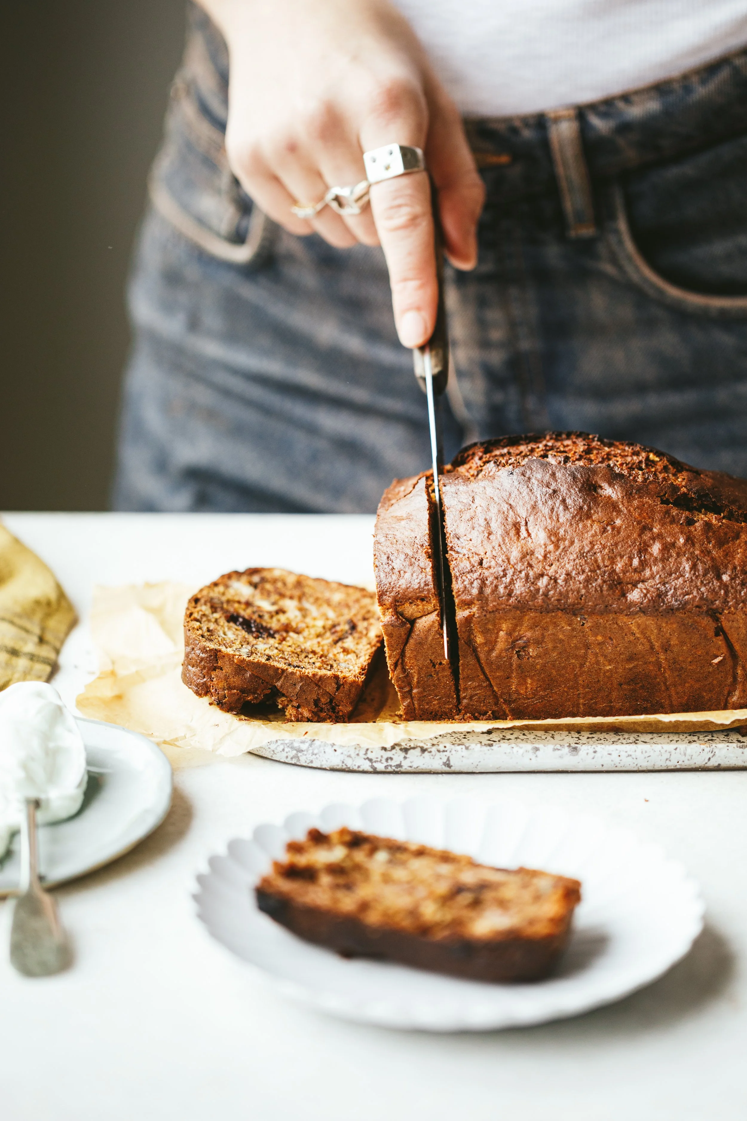 Kimberly Espinel portfolio image showing a hand cutting a slice off a loaf cake.