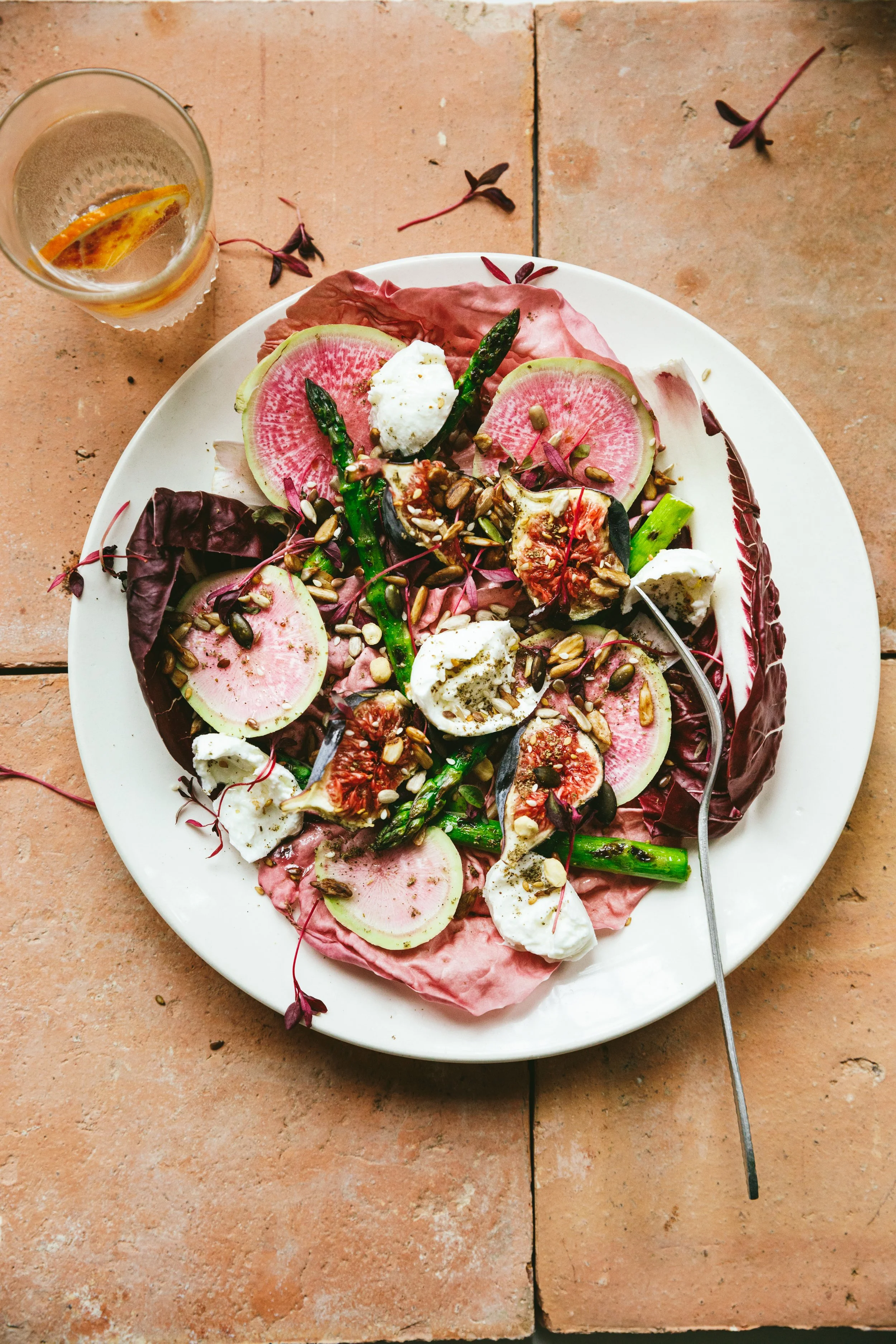Blog post image showing a dish with a colourful salad on a pretty tiled surface