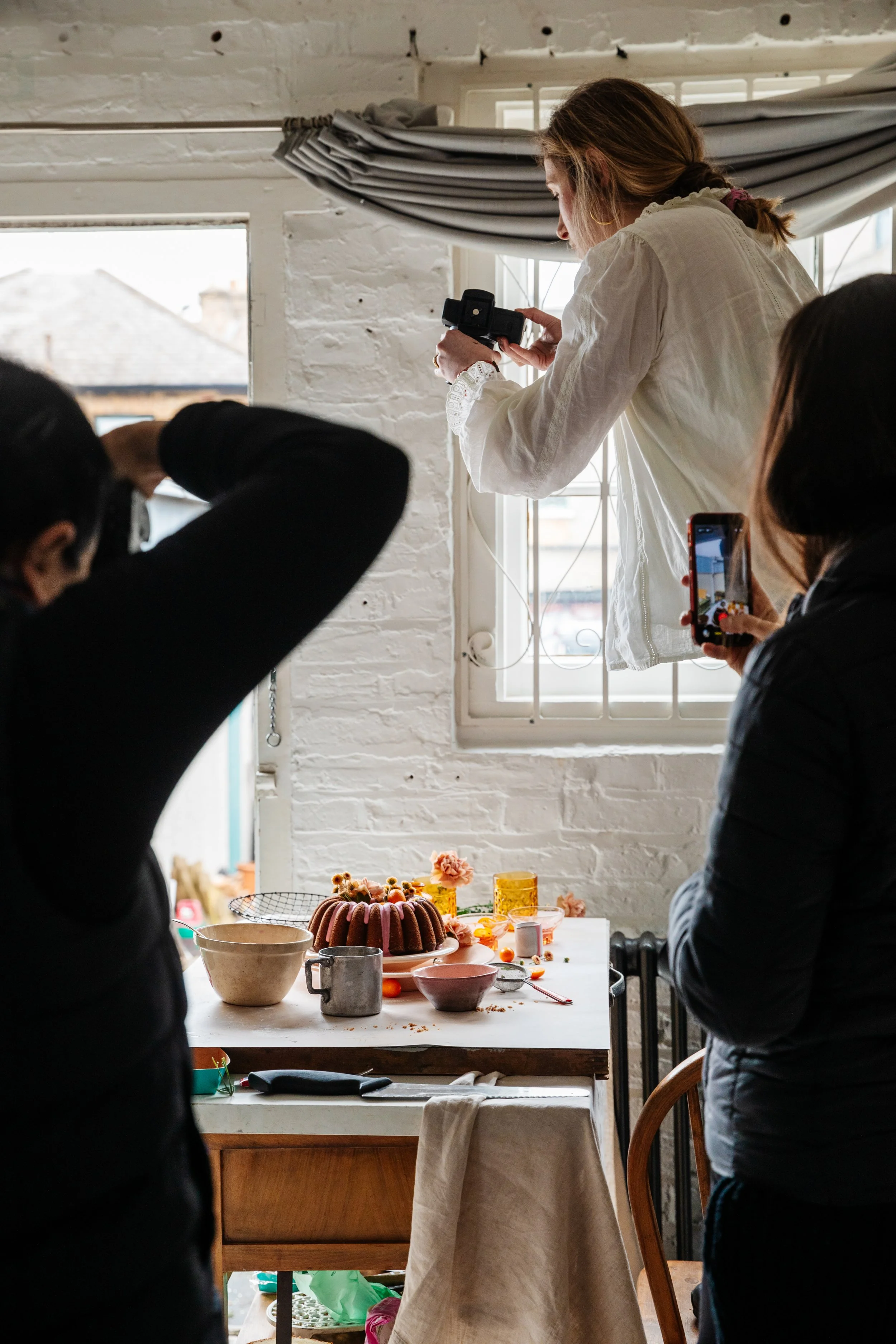 Blog post image showing photographers shooting a food scene set up on a table