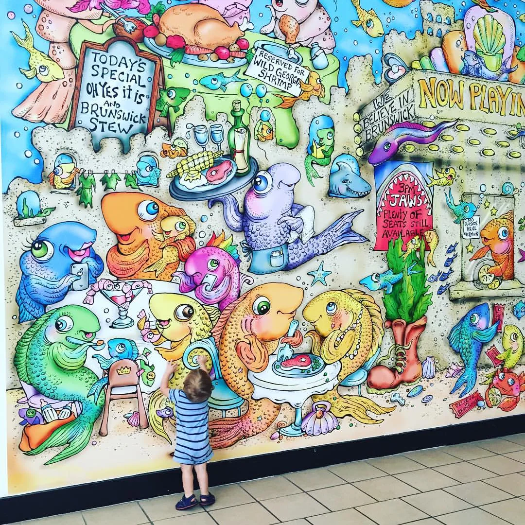 Ed's work towers over my son at the Glynn Place Mall