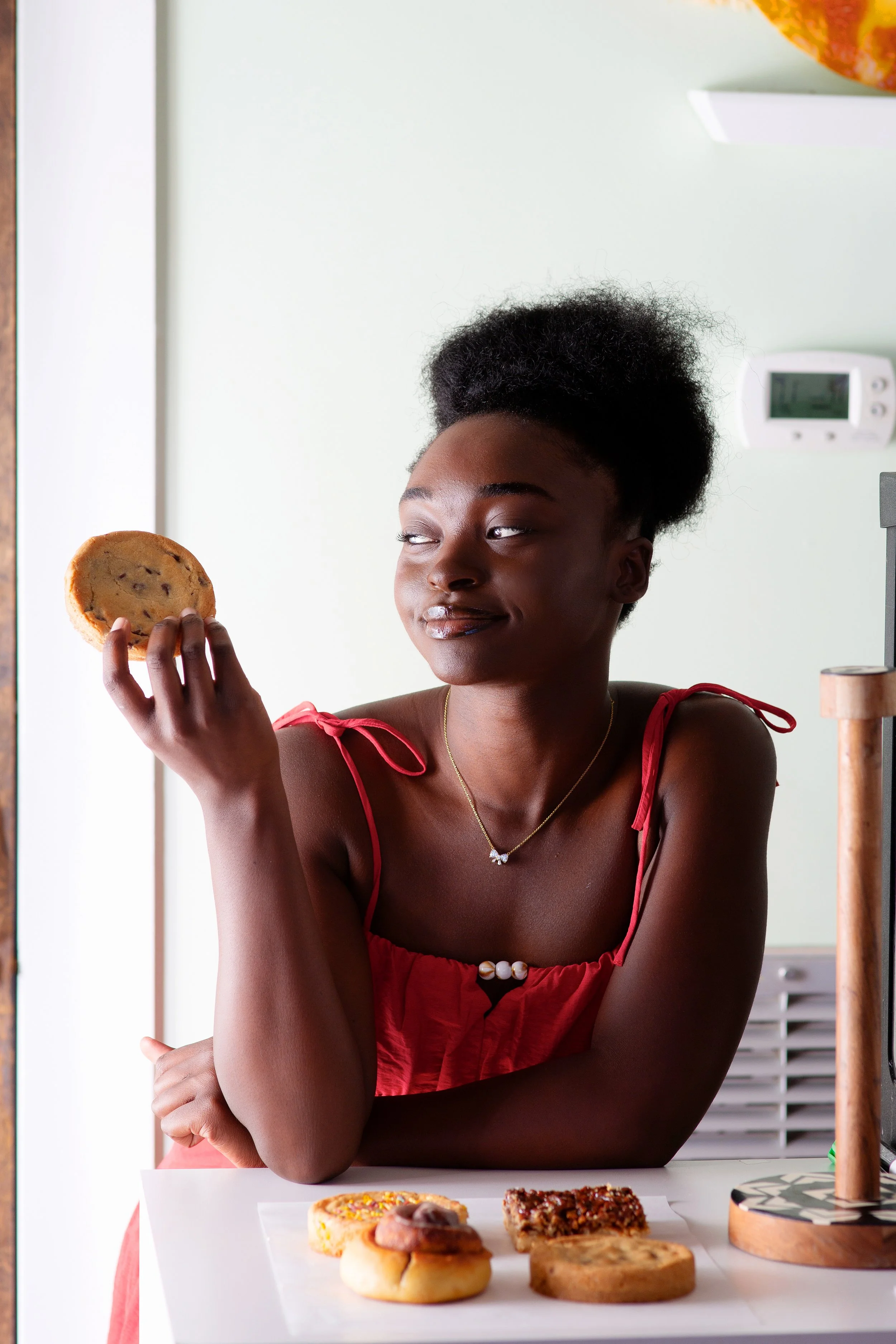 Faith King holding one of her clean chocolate chip cookies, one of many baked goods she offers at her downtown brunswick bakery inside the Brown Butter Shoppe