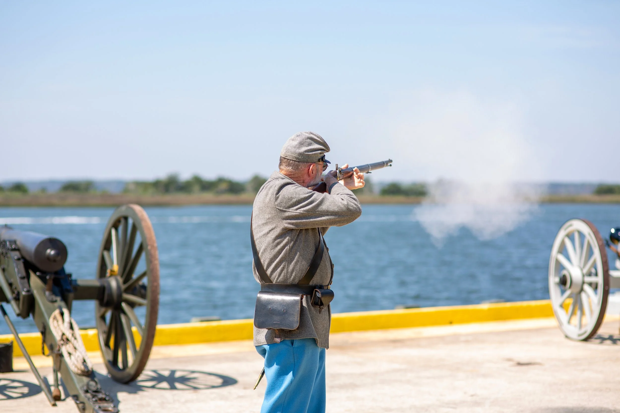 A confederate reinactment soldier fires his musket at the 2026 Mary Ross Waterfront Park in Downtown Brunswick for the 2026 Coastfest event.