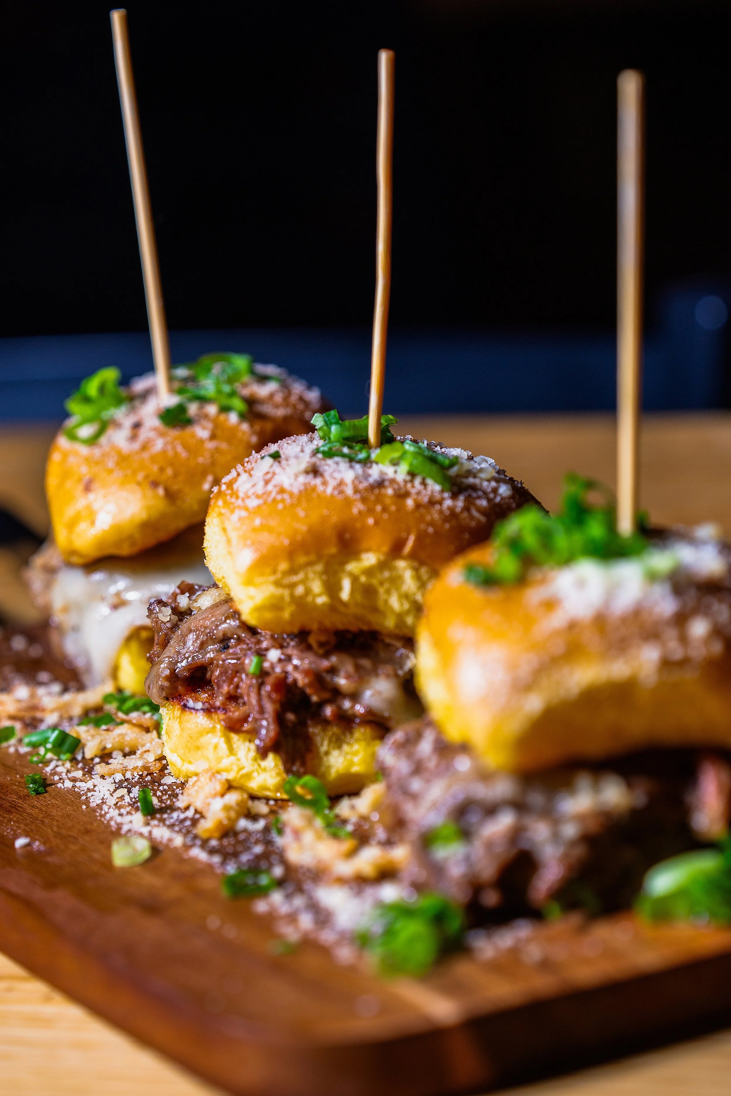 Close-up of gourmet slidered with seasoning and herbs, detailed food photography