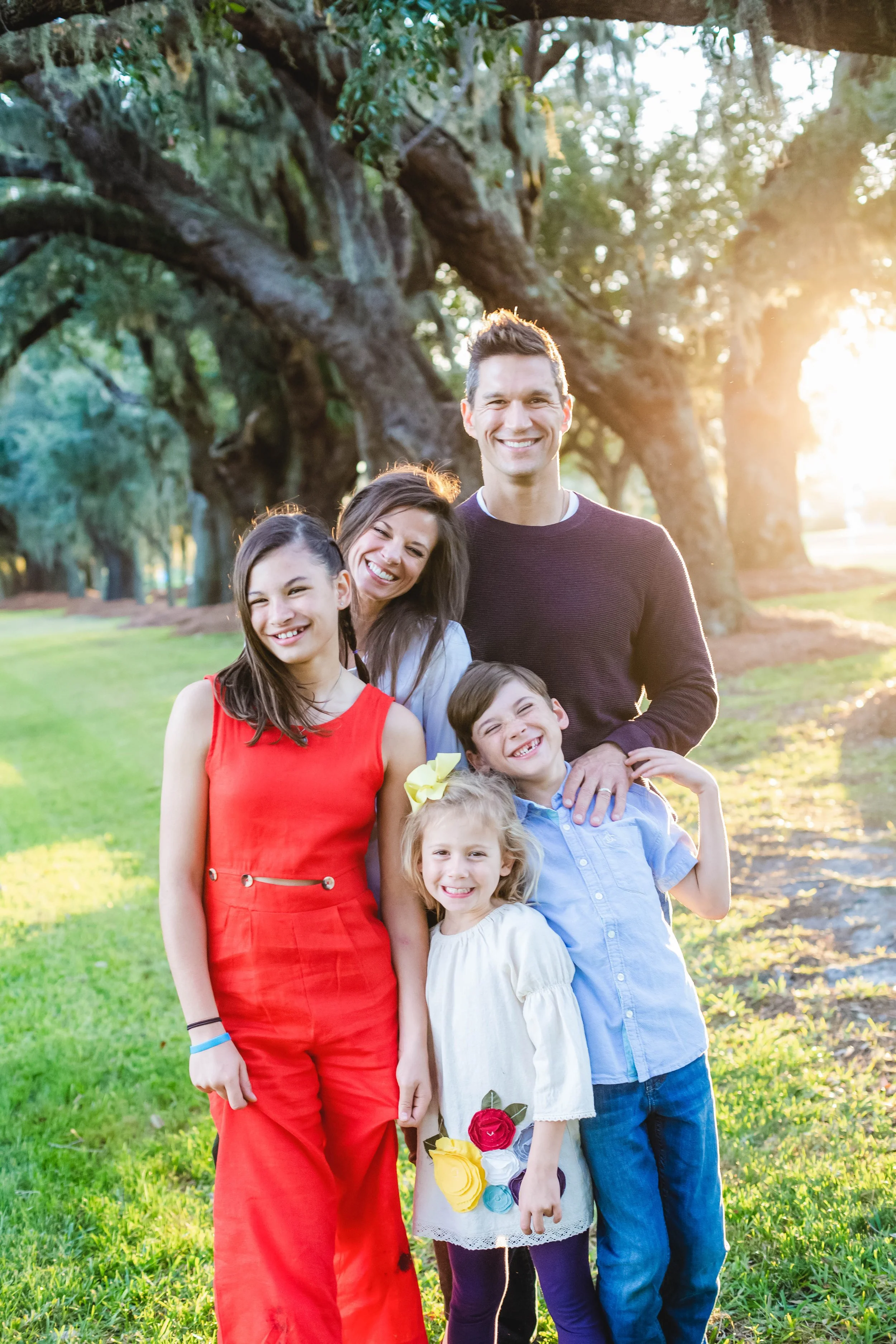 Happy parent and child moment captured in natural light during a St. Simons Island family photography session at Avenue of the Oaks