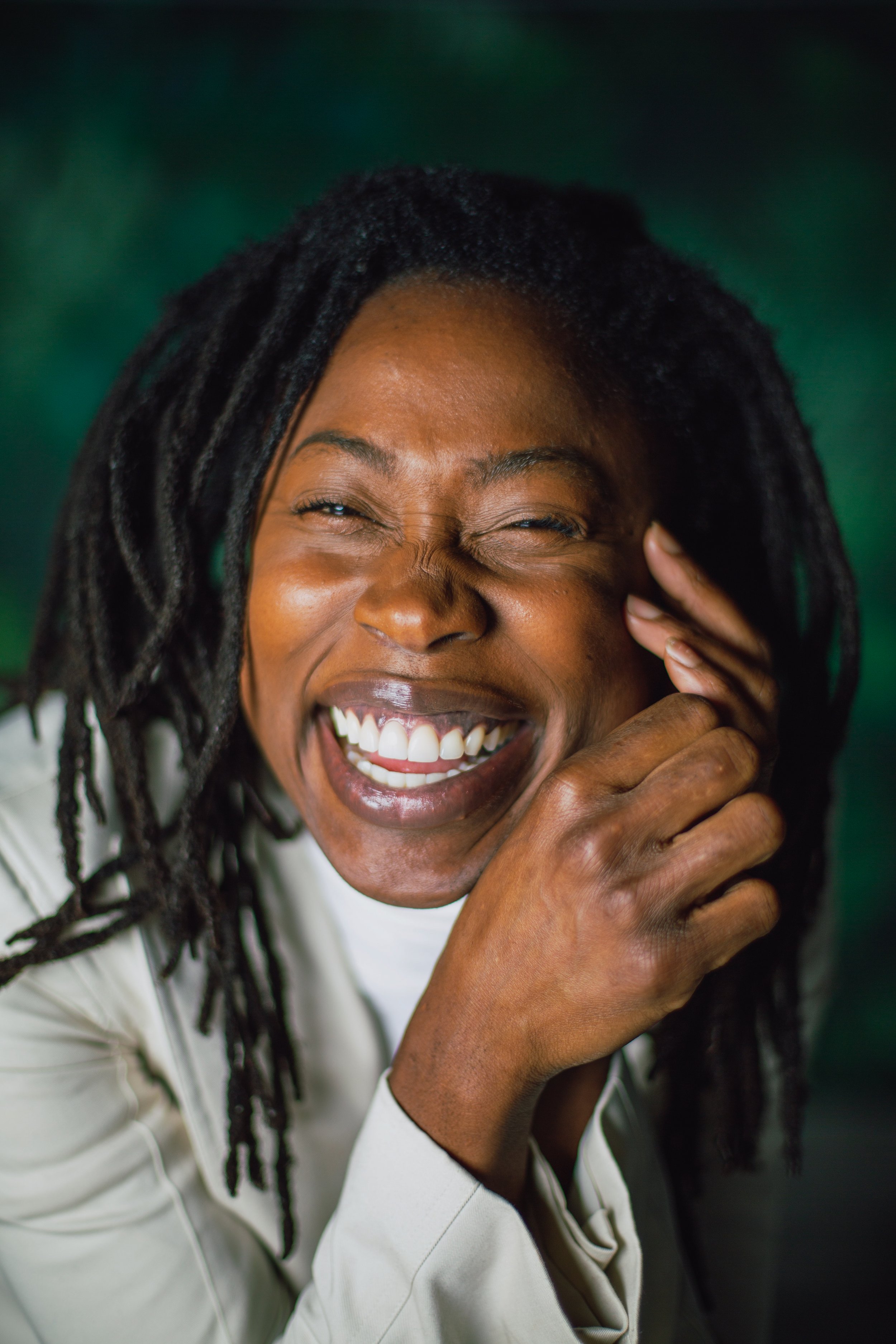 Woman laughing with a natural expression, vibrant and authentic brand portrait