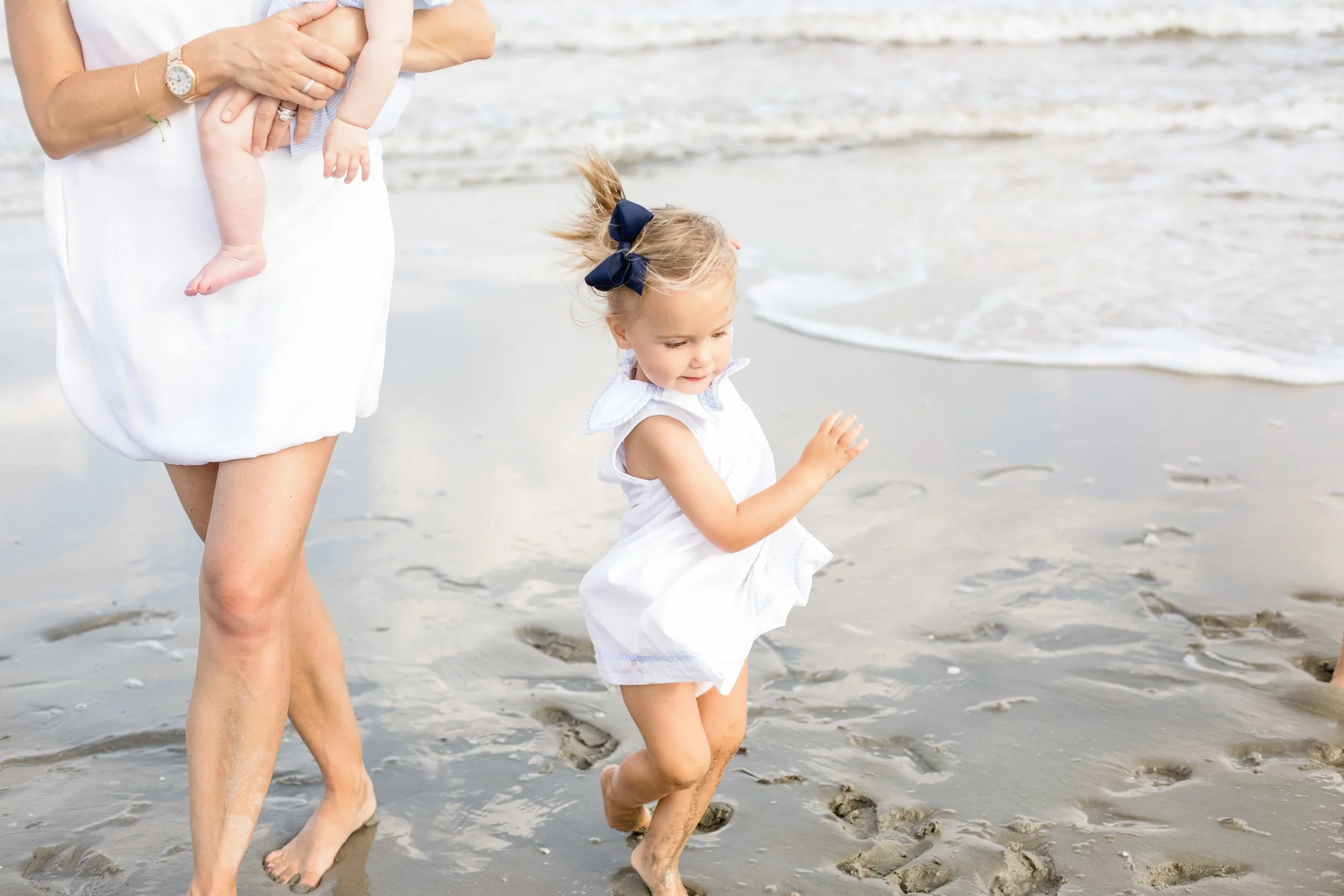 Children playing naturally on the beach during an outdoor family session on St. Simons Island captured by a storytelling photographer