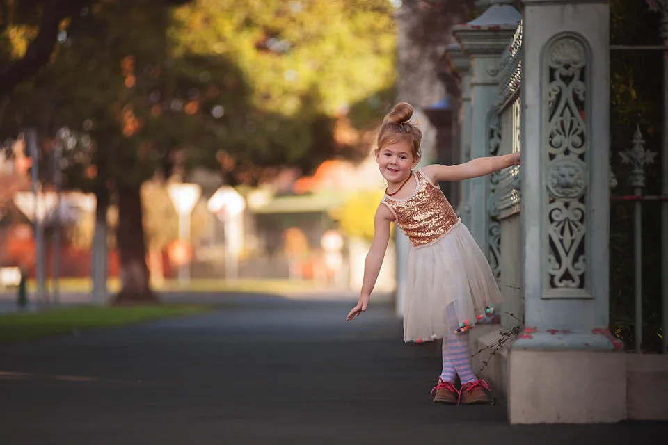 Child hanging on fence