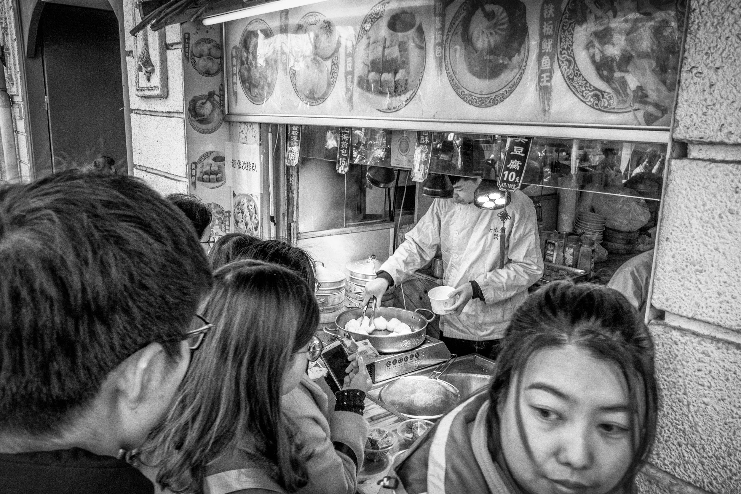 People queuing to buy dumplings in Shanghai, China. March 2018.