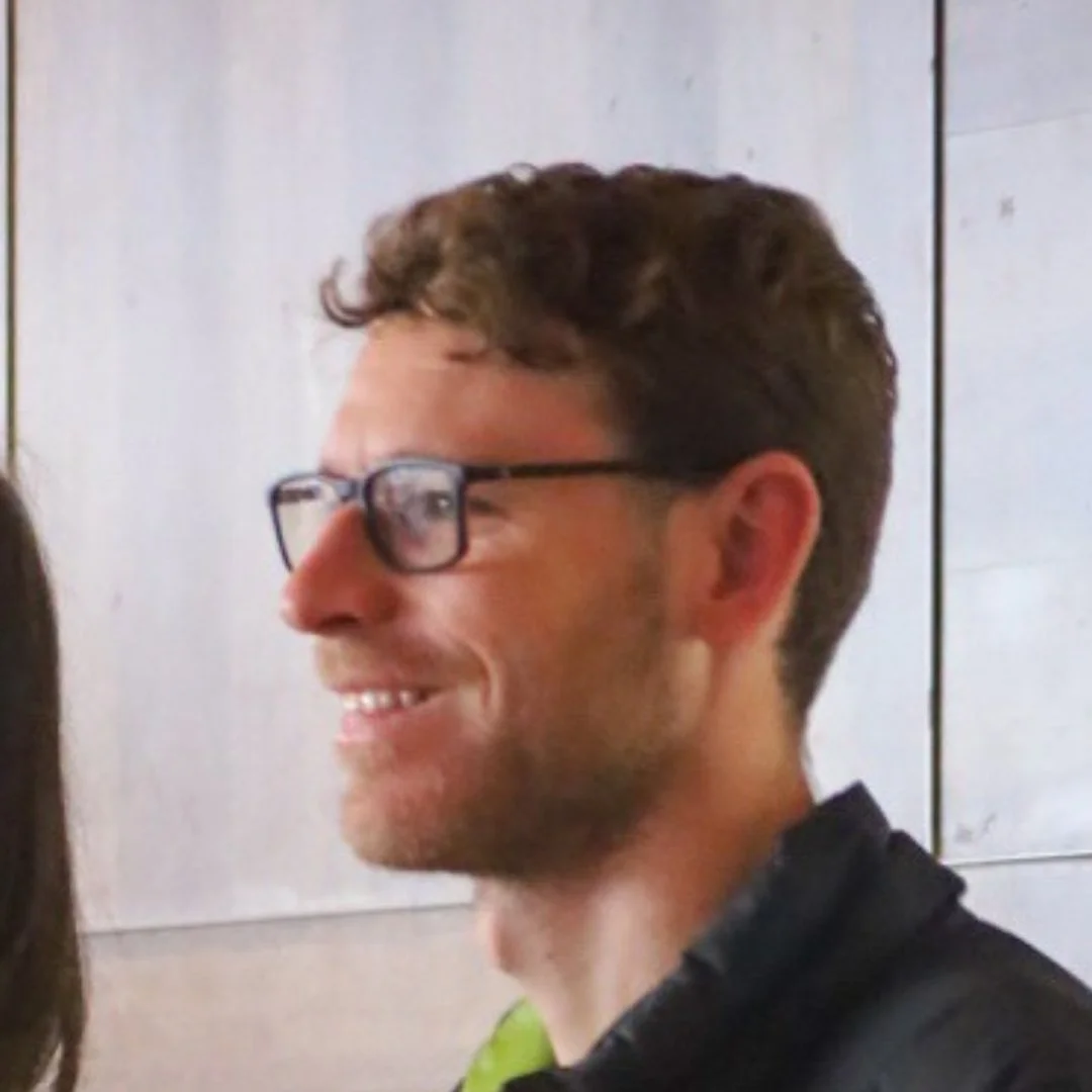 Smiling man wearing glasses in side profile