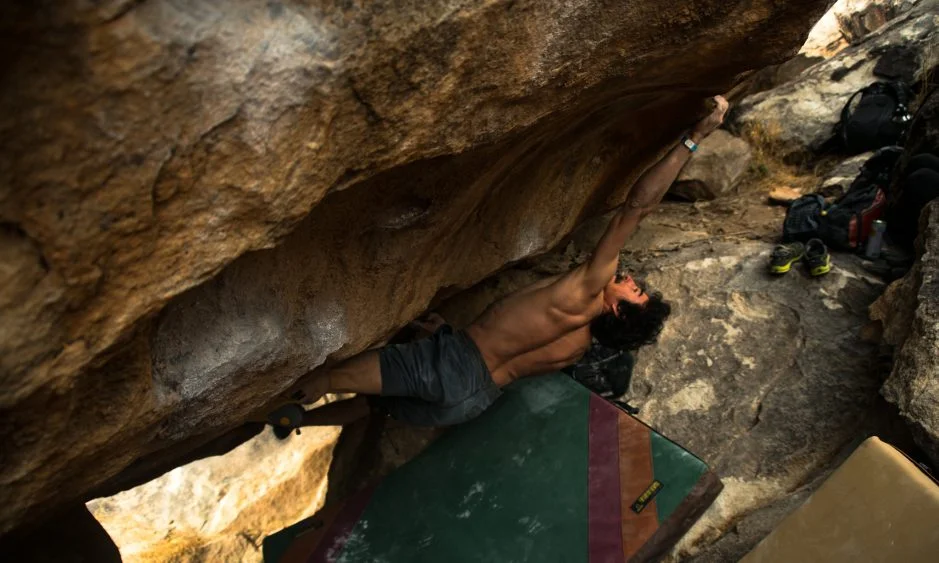Keenan Takahashi—the winner of at Open Division at the 2018 Hueco Rock Rodeo, in Hueco Tanks, Texas—stays calm and fights off the pump on Chupacabra Right (V11). Photo: Levi Harrell. 