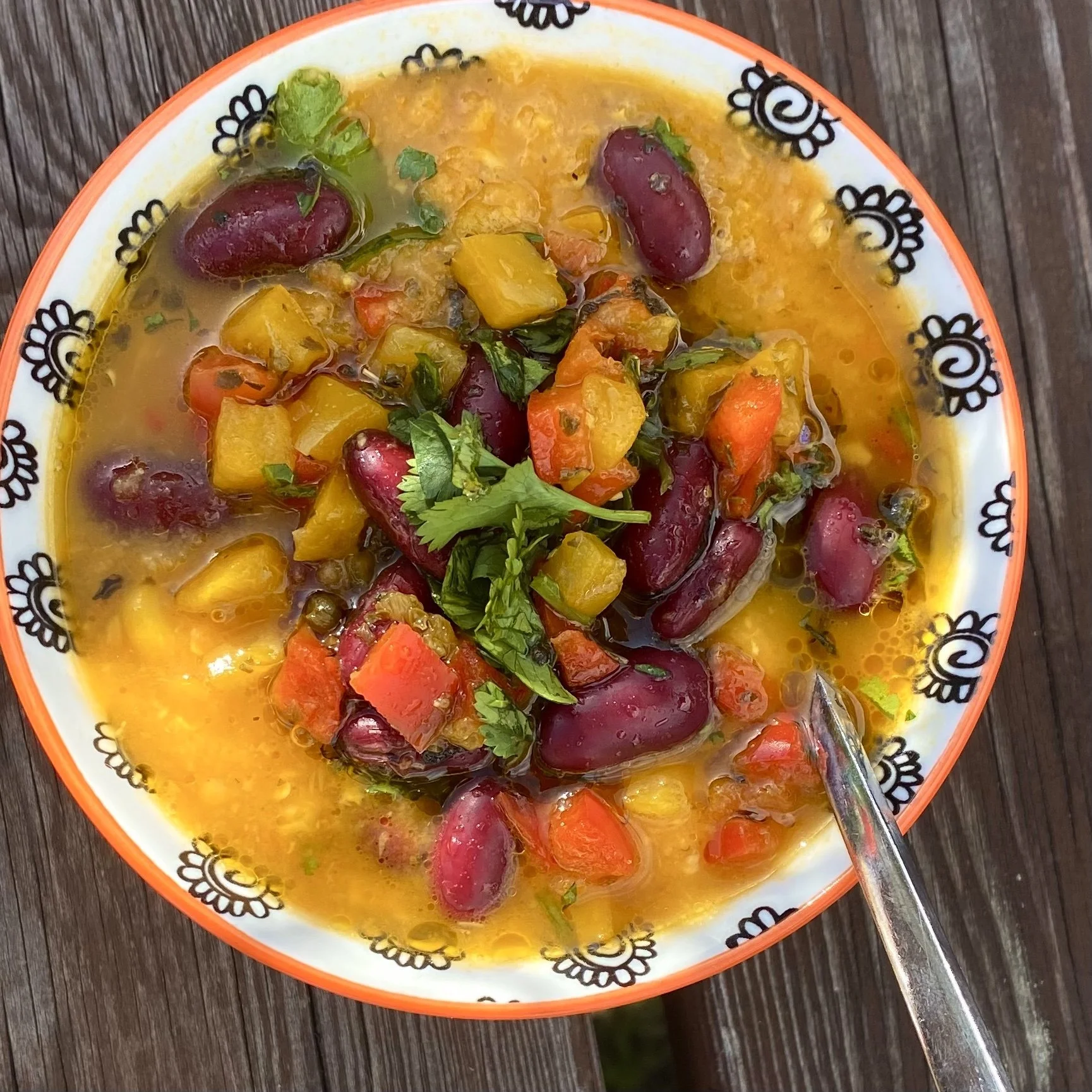 Nourishing Mexican Corn Soup with sweet potatoes, carrots, sweetcorn, celery, onion, garlic, red lentils, cumin, sweet smoked paprika, chipotle,  red kidney beans, herby sweet peppers, lime juice and coriander