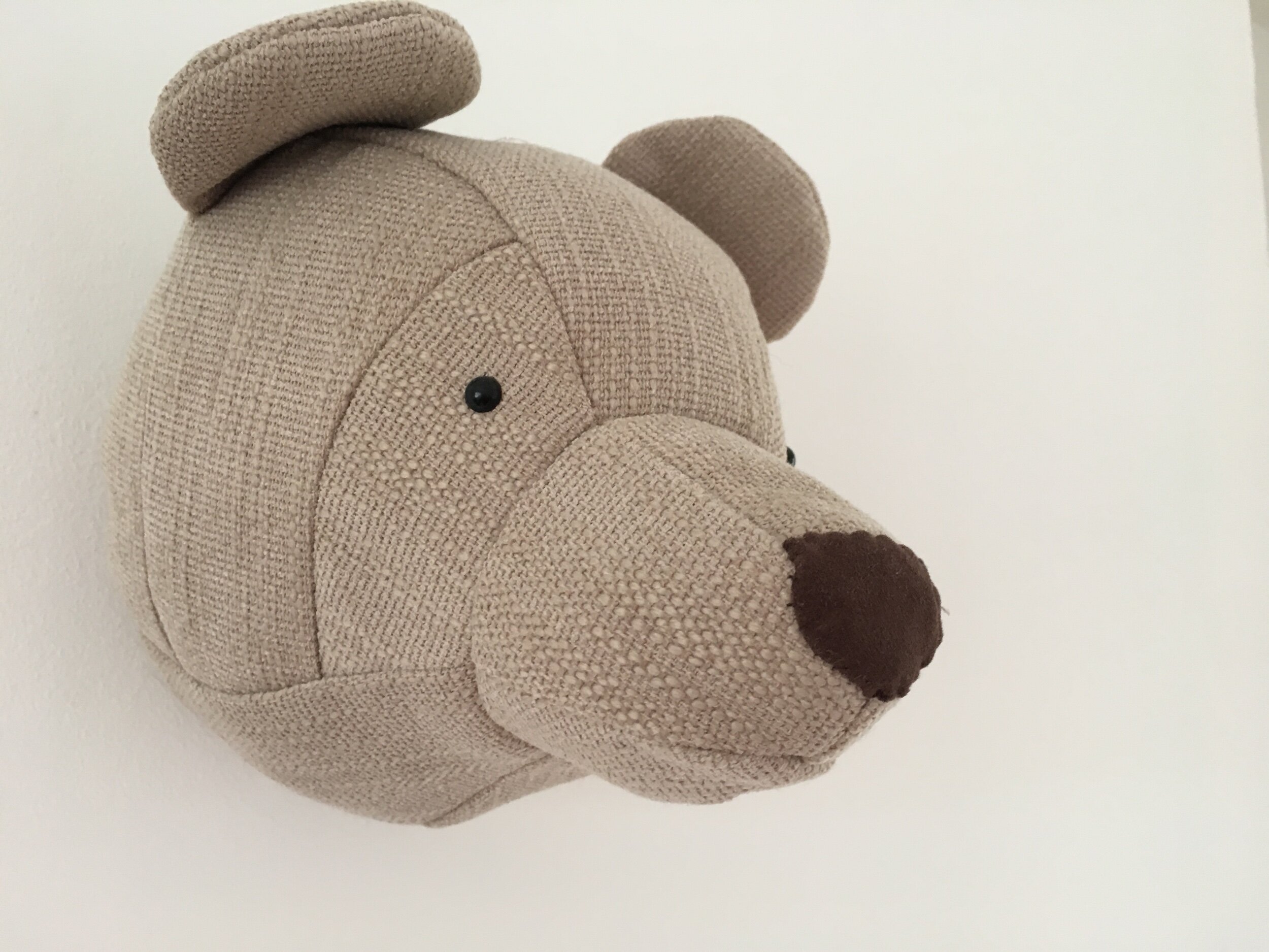 A teddy bear head is the ultimate in stylish nursery accessories and this one ticks all of the boxes . Made to an incredibly high standard this little grizzly looks elegant and fun on any nursery wall.