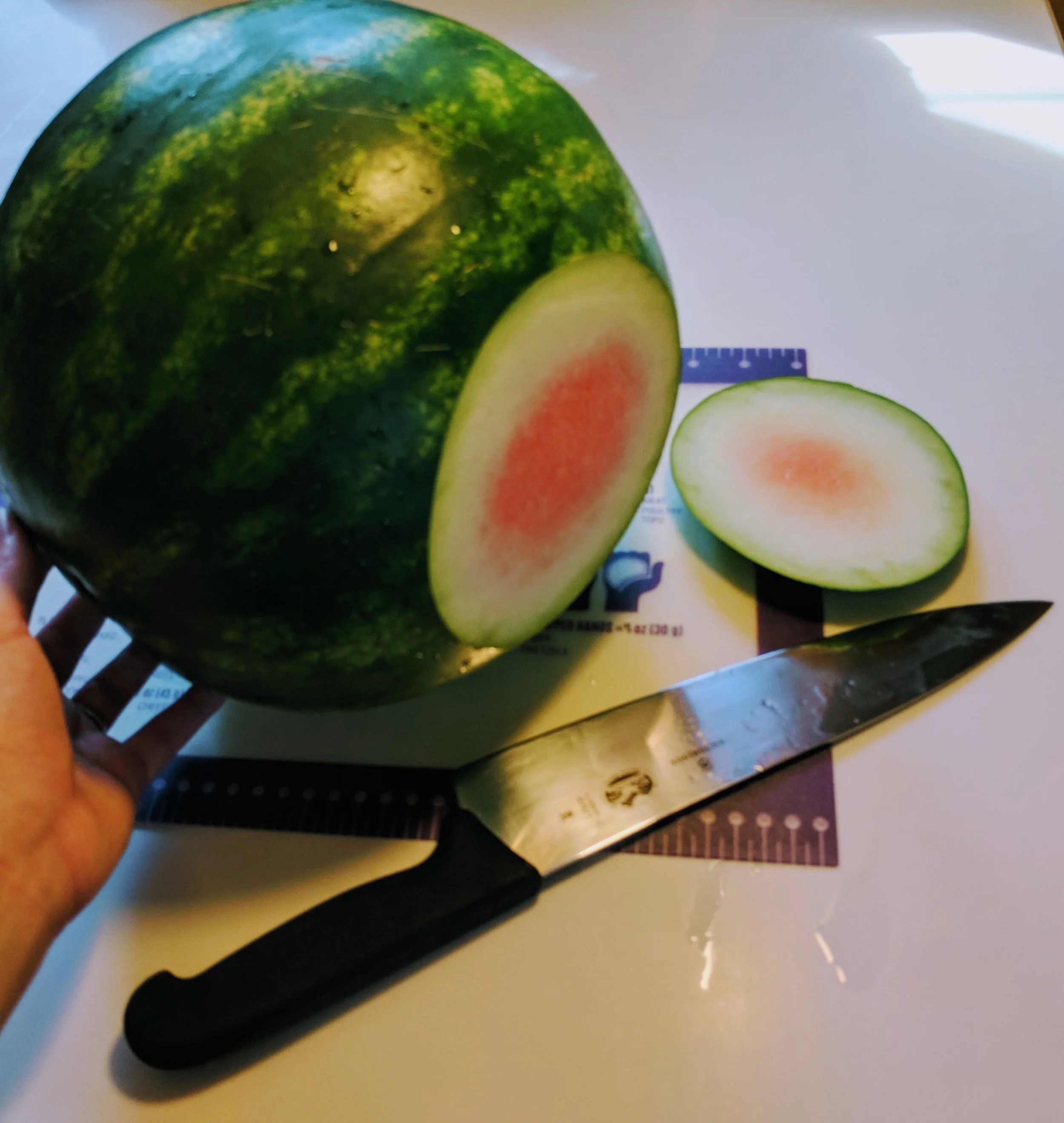 This small, shallow, controlled cut is a little safer than trying to slice all the way through a rolling melon.