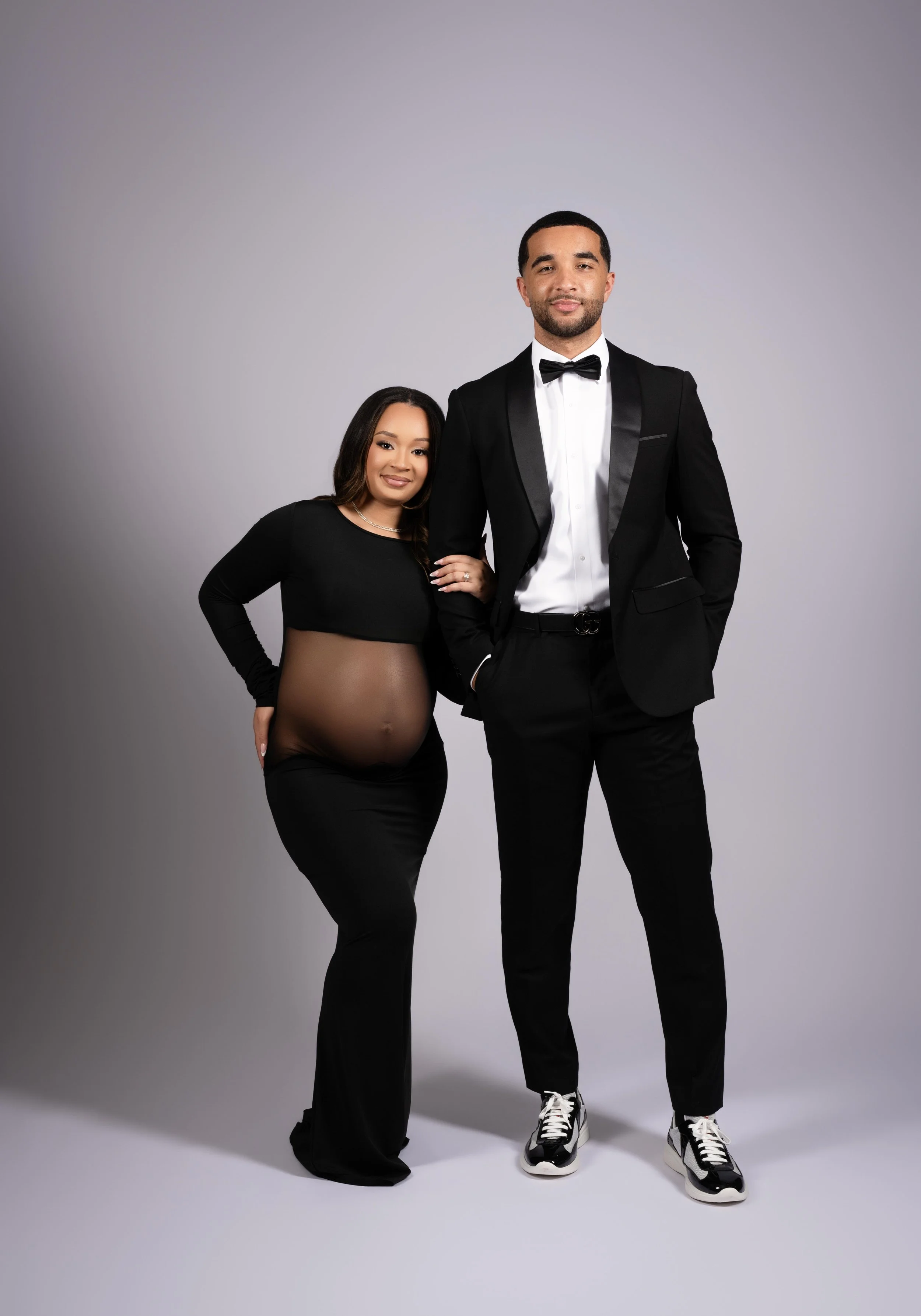 Fashion-inspired maternity portrait with partner in formal attire, photographed in Frisco, Texas.