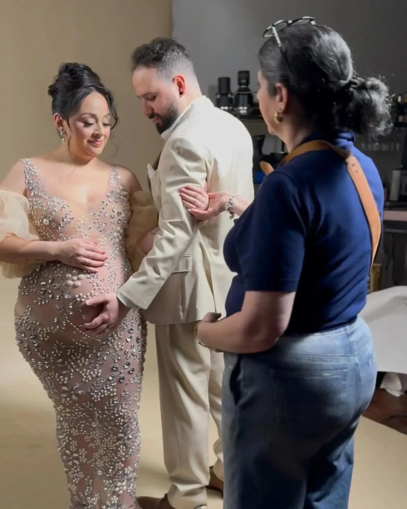 Photographer guiding a couple’s pose during a luxury maternity photography session in Dallas.