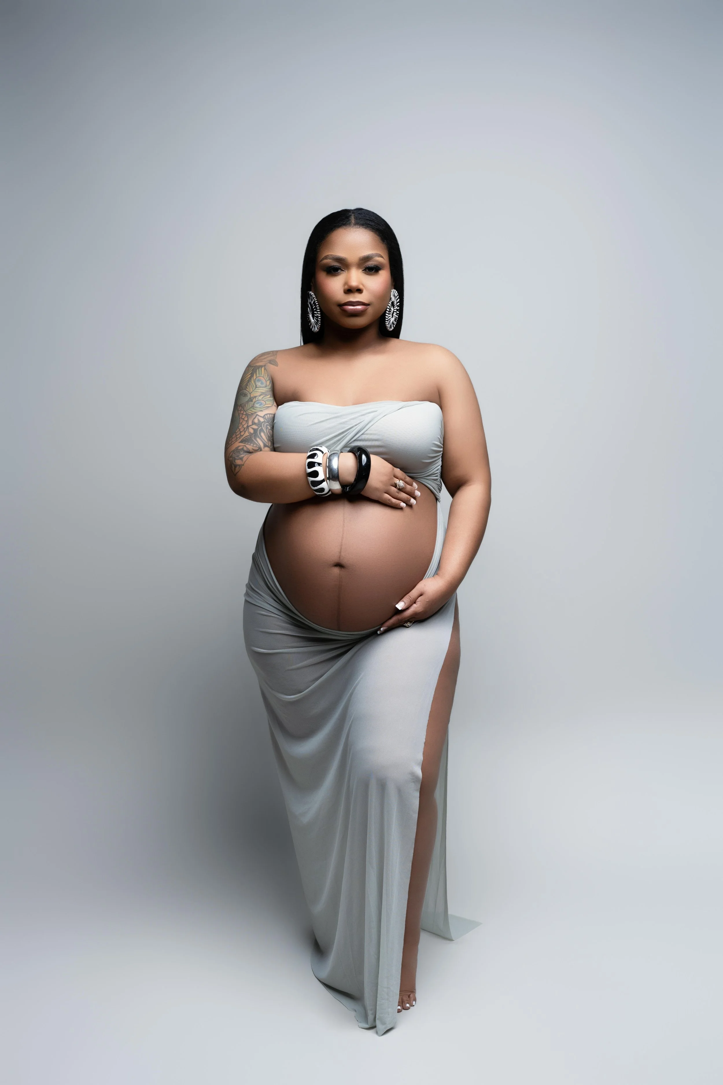 Editorial studio maternity portrait in a silver draped look, photographed in Frisco, Texas.