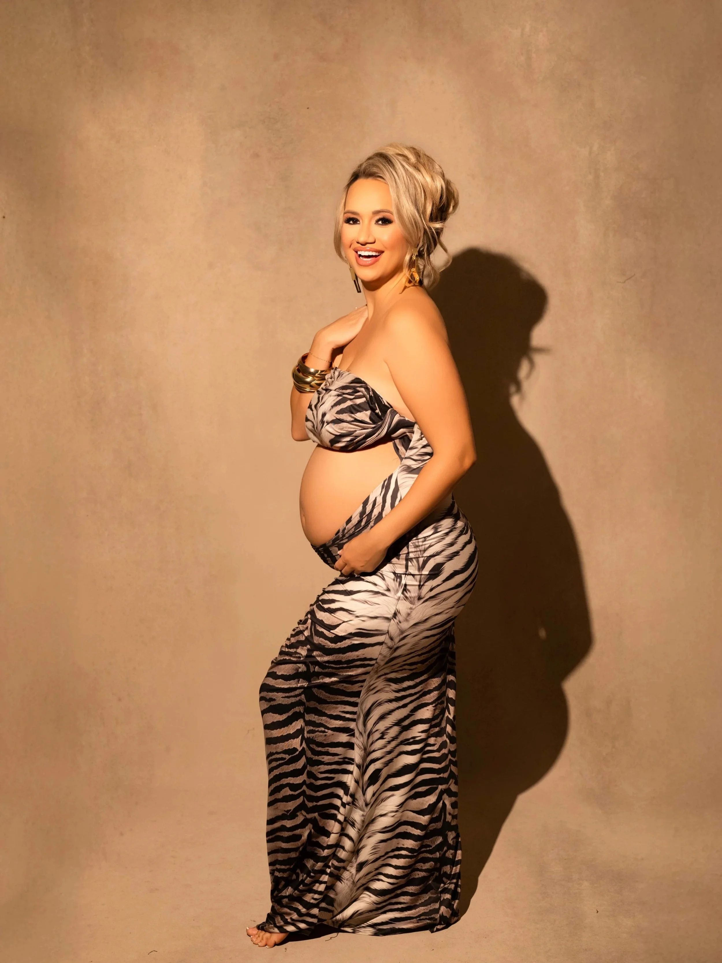 Pregnant woman posing in a fashion-forward maternity photoshoot at a Carrollton, TX photography studio