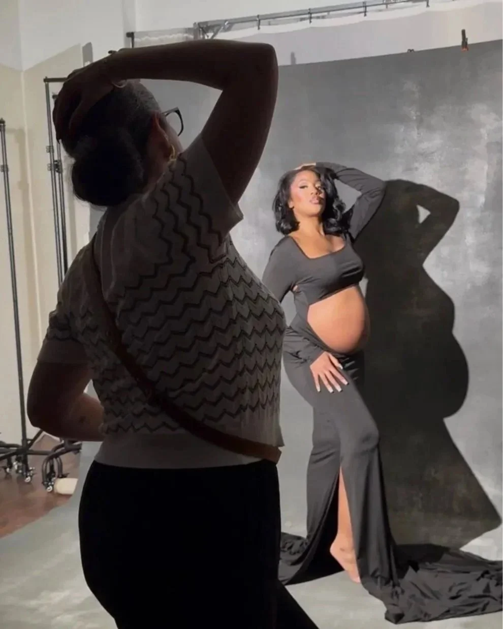 Photographer directing and posing a pregnant client during a maternity photography session in Dallas.