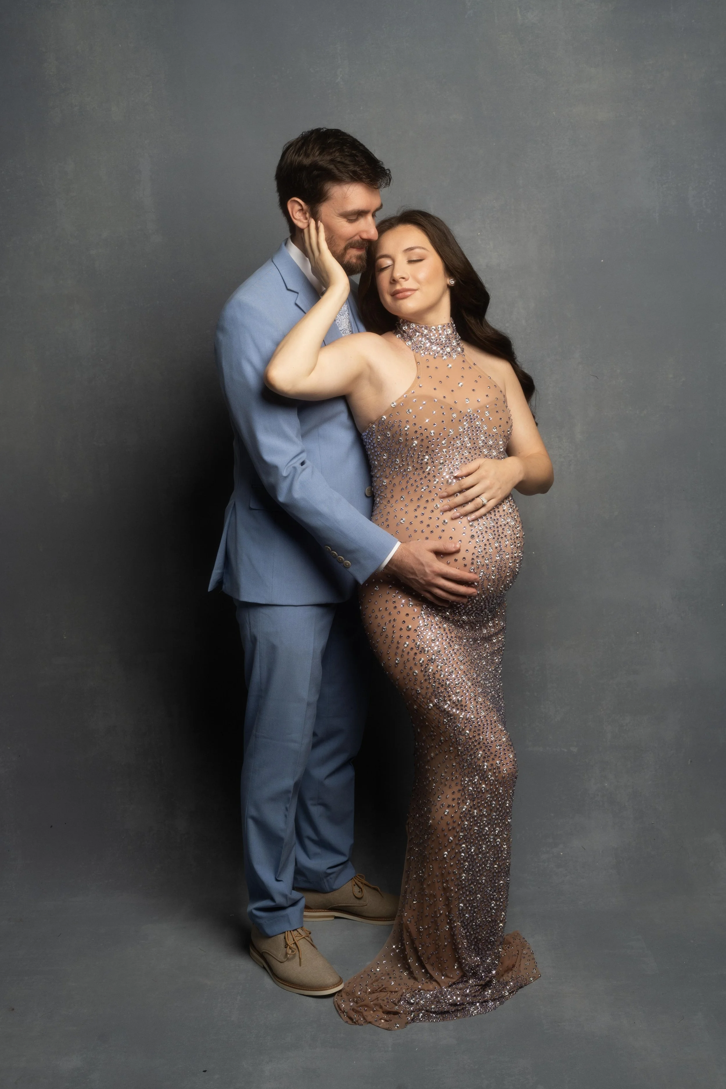 Expectant couple embracing during their Dallas maternity photography session.