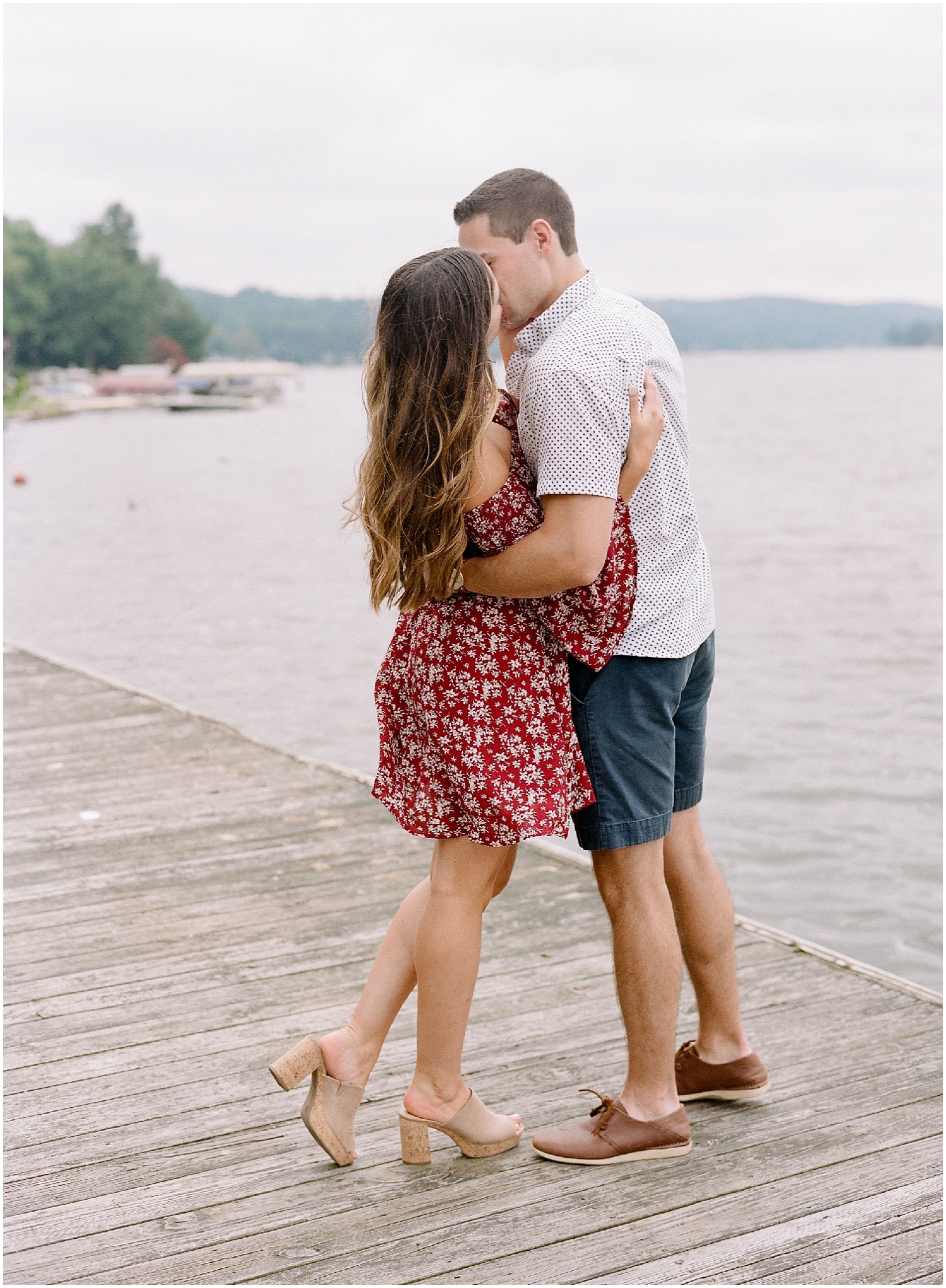 secret proposal, northern new jersey, newly engaged couple smiling and laughing, having fun on the boardwalk near the lake