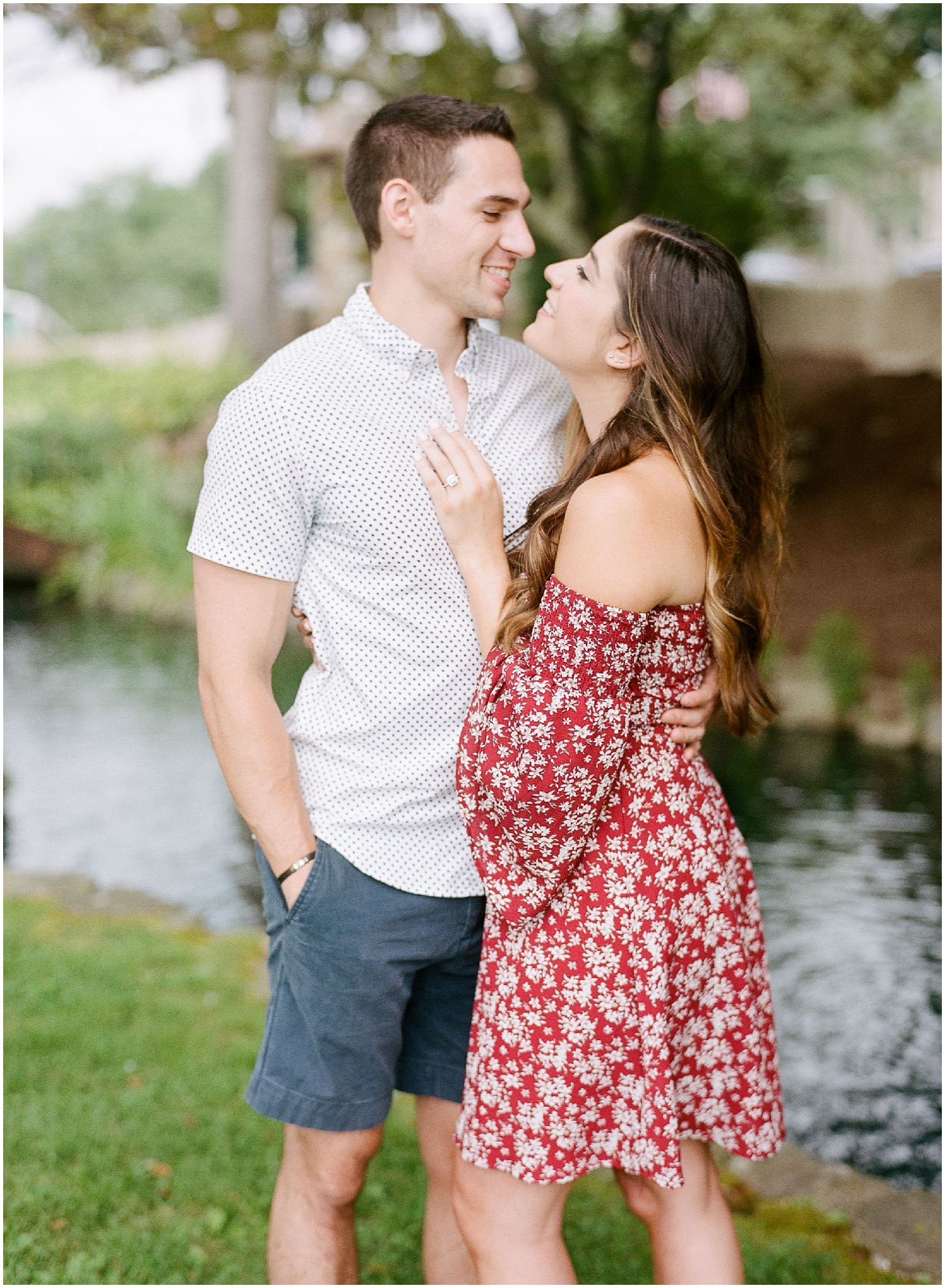 secret proposal, northern new jersey, newly engaged couple smiling and laughing, having fun on the boardwalk near the lake