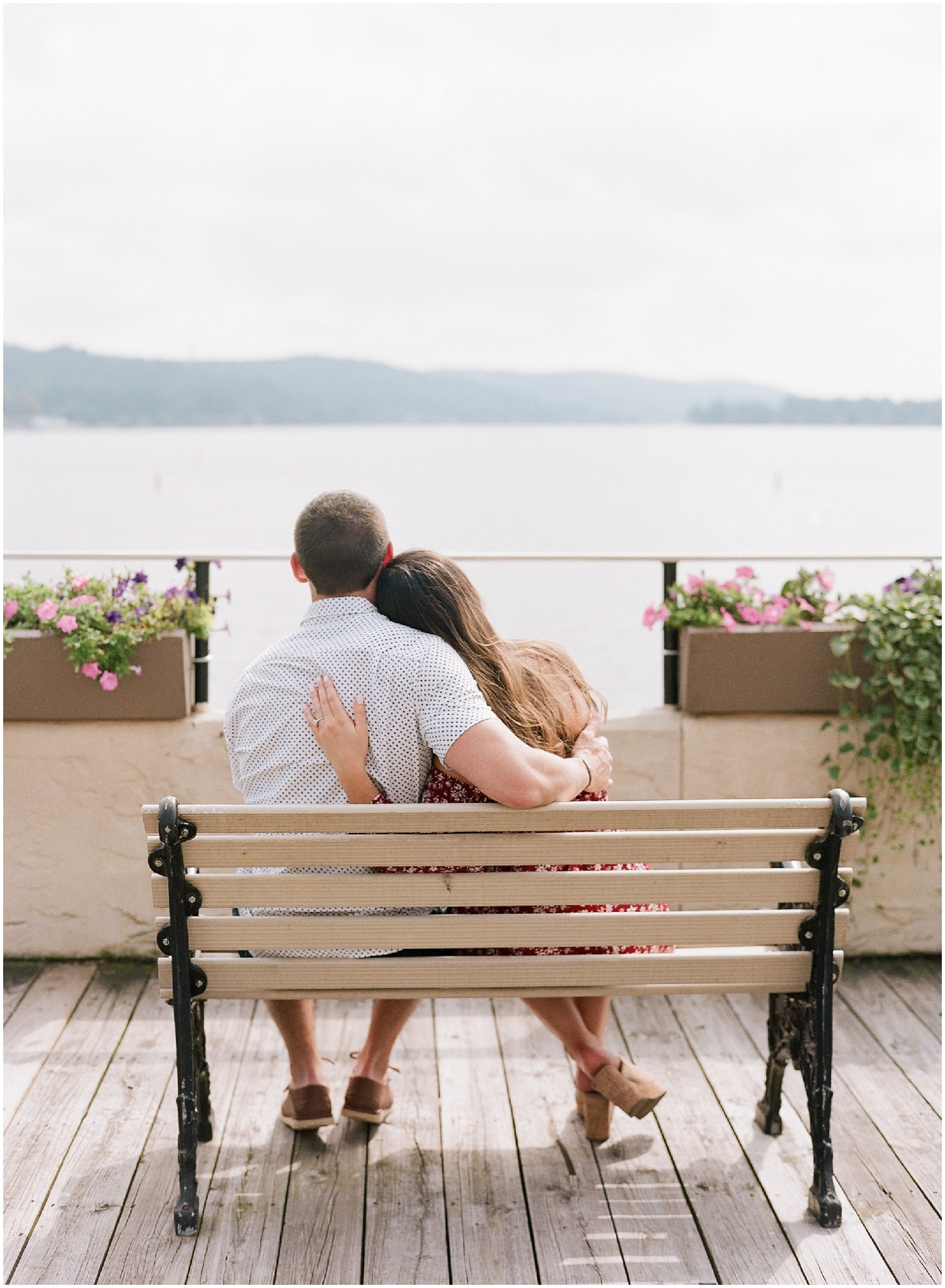 secret proposal, northern new jersey, newly engaged couple smiling and laughing, having fun on the boardwalk near the lake