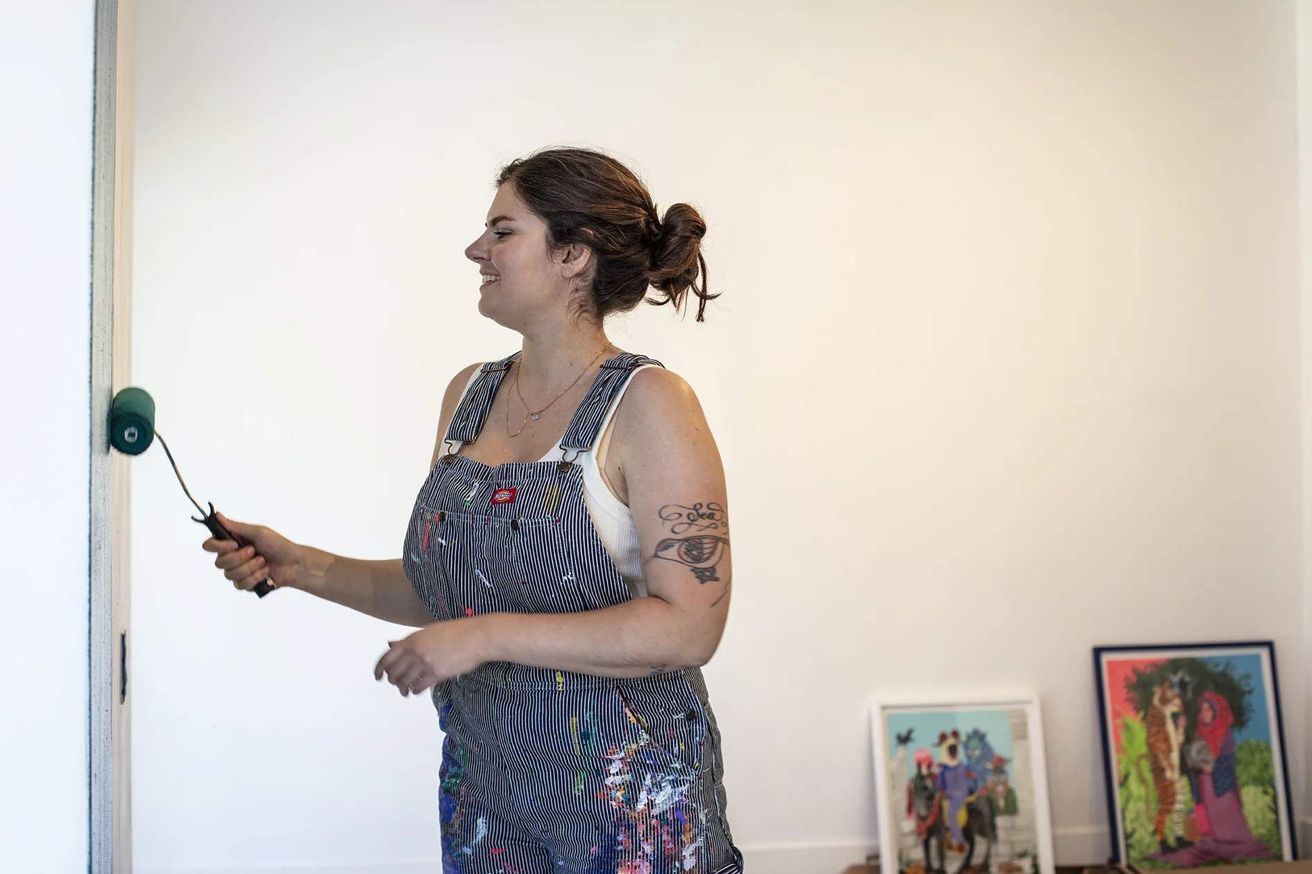 Artist, Stacey Rozich, installing her latest body of work, “Some Sort of Disrepair.”  Behind the scenes photo by L. Herrada-Rios