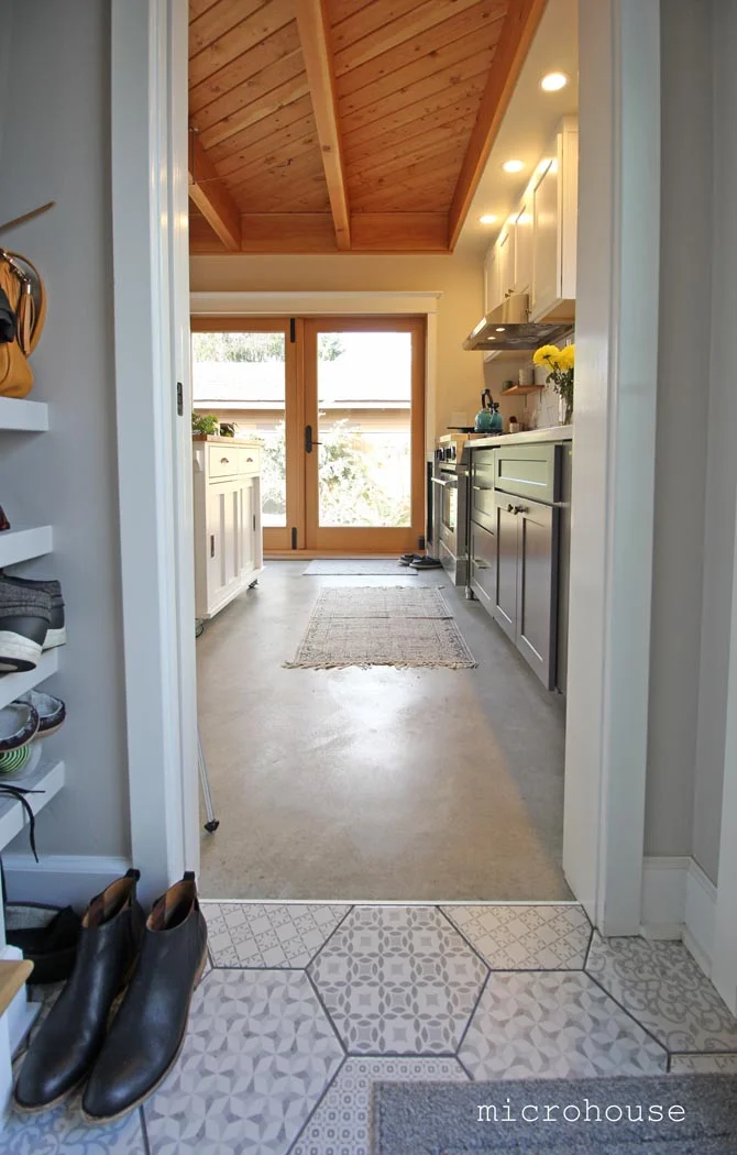 Ceramic tile accentuates the entry area. The view from the entry towards the kitchen and patio beyond.
