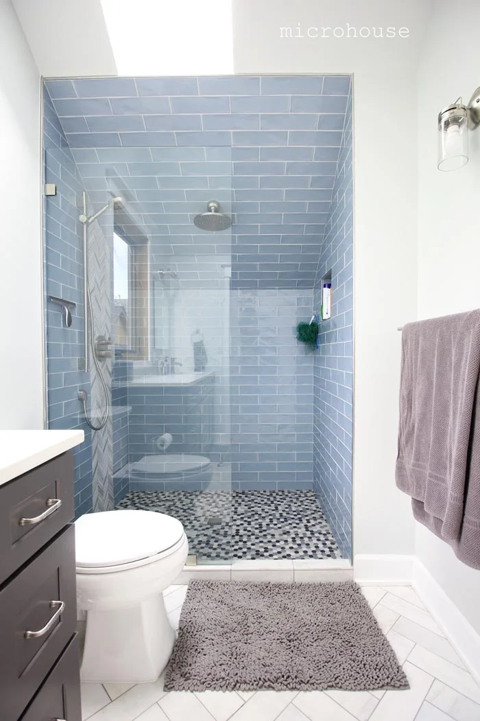 The shower is tucked into an under eave space. 