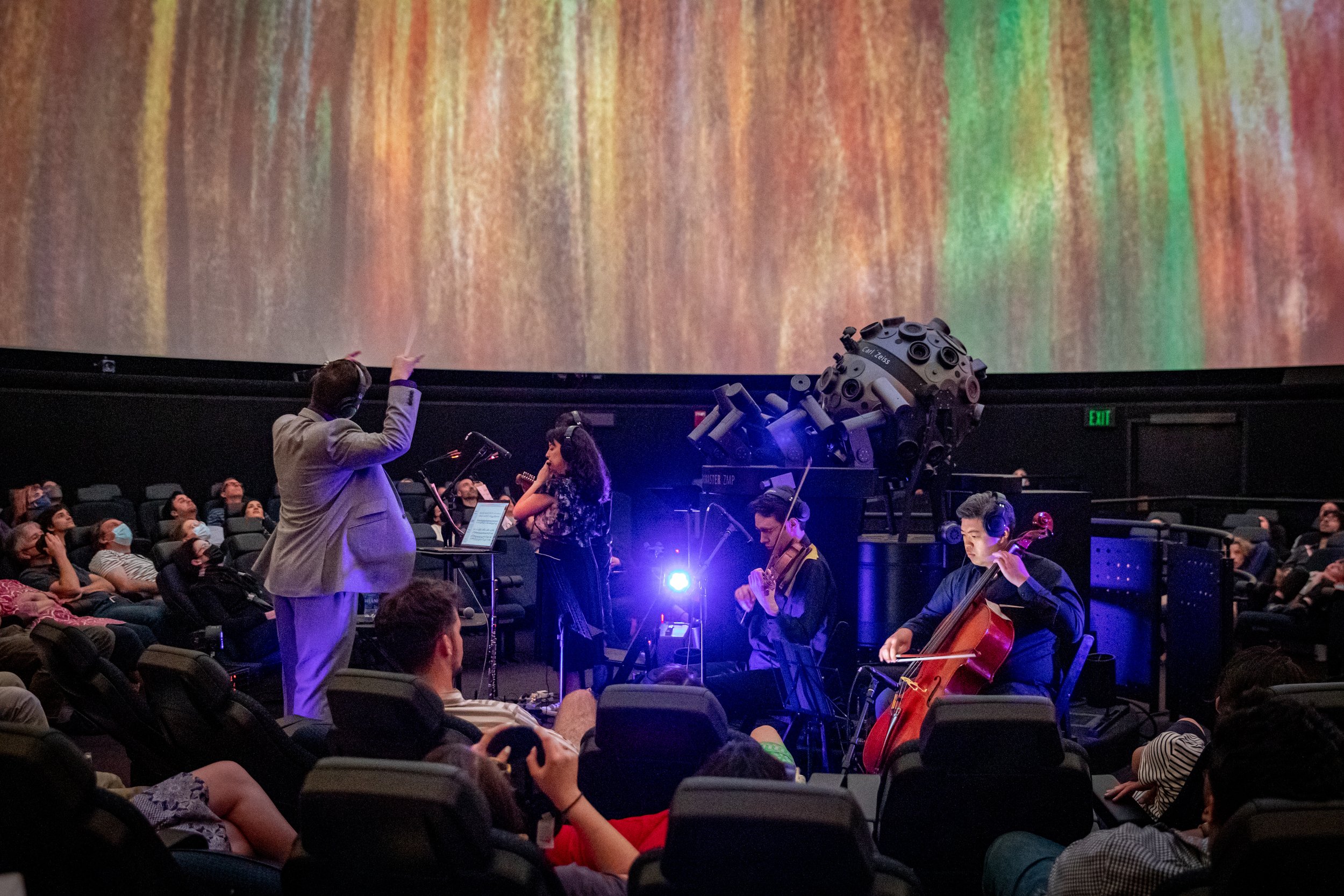 David conducting at the Black Hole Symphony Premiere, Museum of Science, Boston