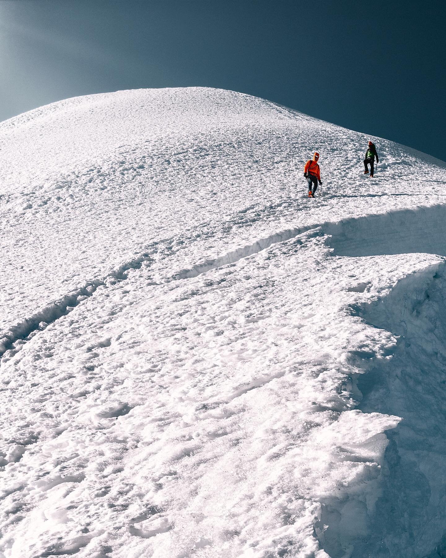 Swipe ⬅️ for full photo! One quick look back before putting the camera away. Tired and stoked. Three friends and one giant mountain.