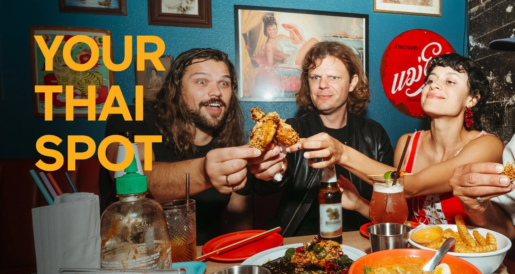 a group of happy friends toasts with chicken wings