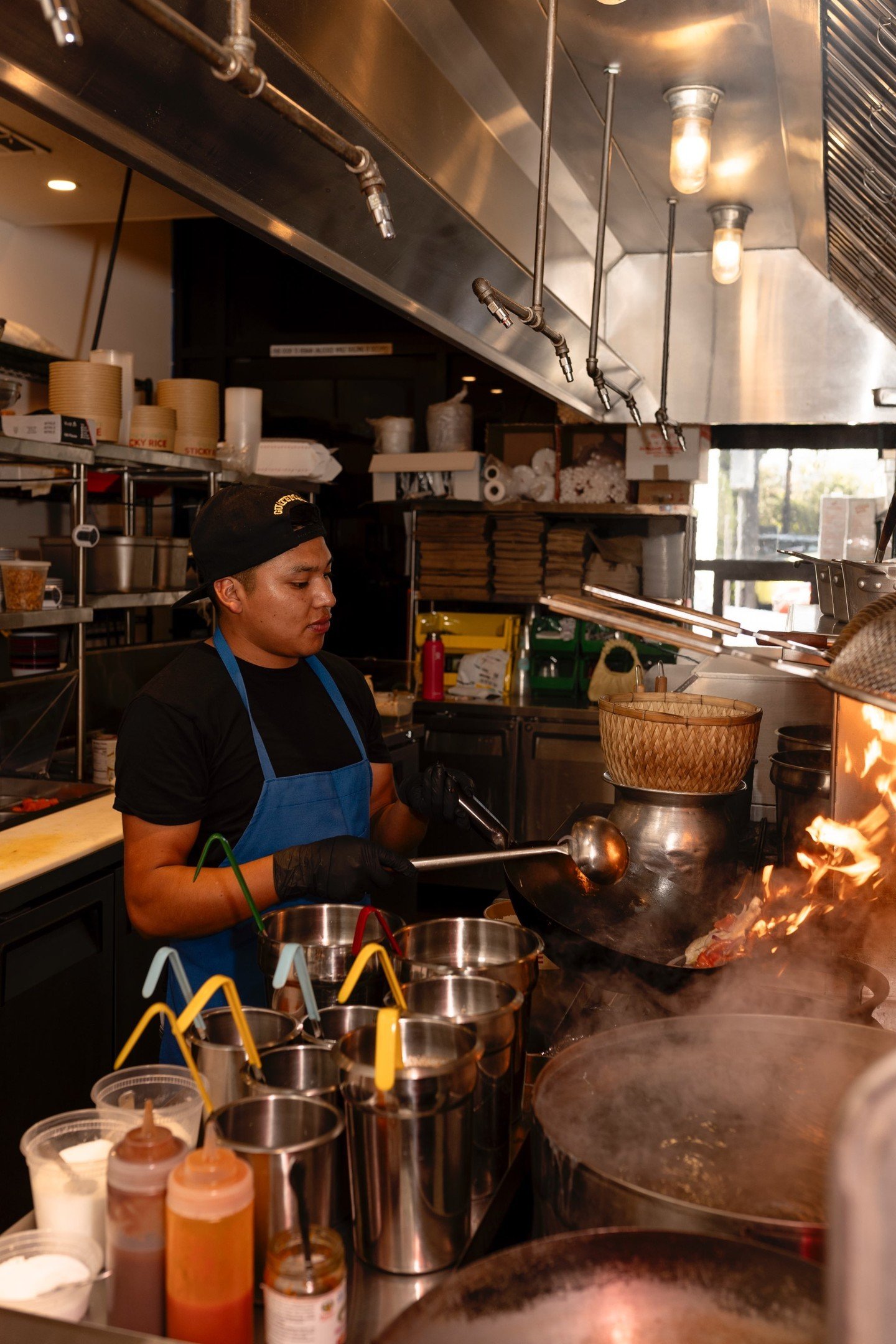 When Emanuel came to us a few years ago he had no experience cooking Thai food. Now he makes it look easy. 🔥 By the time we were ready to open our newest (and shiniest) kitchen, we knew he was the man to lead the team. Be sure to peak through the wi