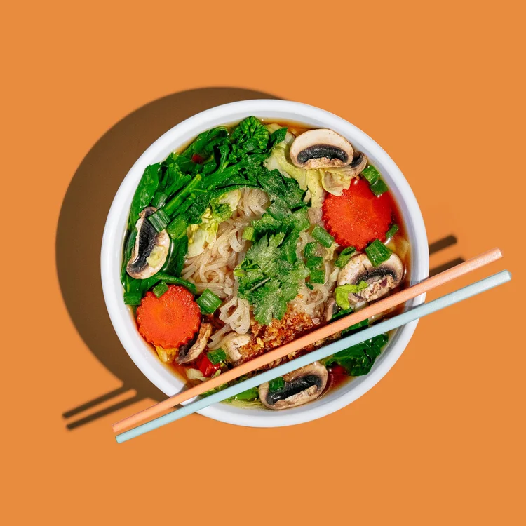 Vegetable noodle soup with mushrooms, carrots and greens
