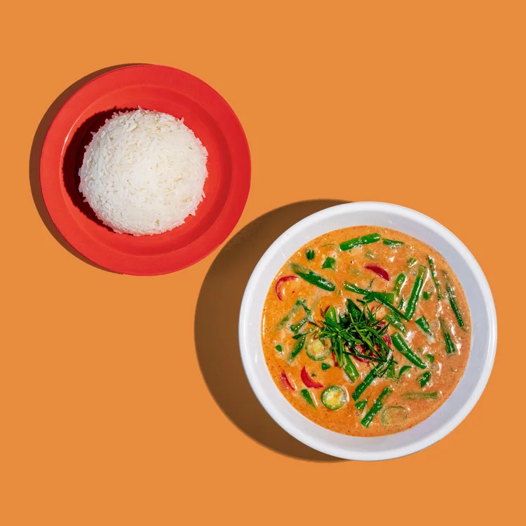 Panang curry with vegetables and herbs, served with rice