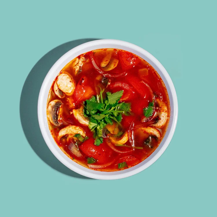 Tom yum soup with mushrooms, tomatoes and herbs