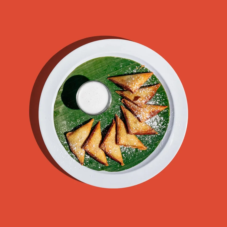 Crispy banana samosas dusted with sugar