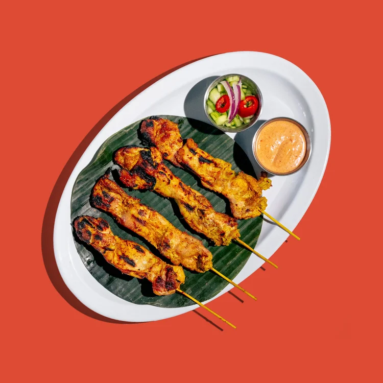 Chicken satay skewers with peanut sauce and cucumber salad