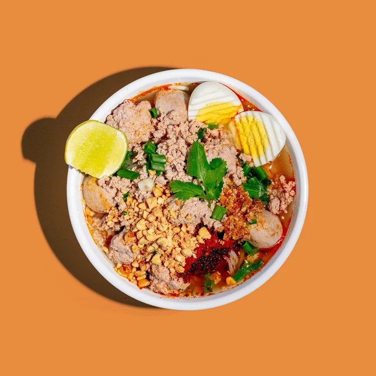 Tom yum noodle soup with minced pork and peanuts