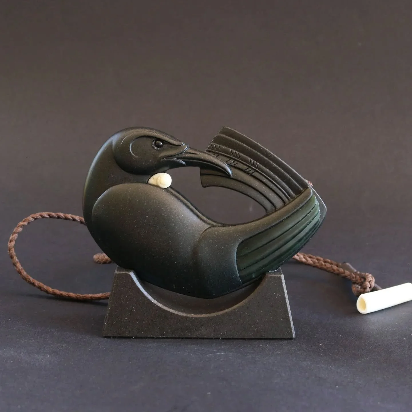 It's been quite some time since I last carved a Tūī. This piece is a commission that I finished a few weeks ago. The Tūī is made from basalt with a pounamu wing feather insert, whalebone tuft, black serpentine eye and a stand made from ōnewa. It's a 