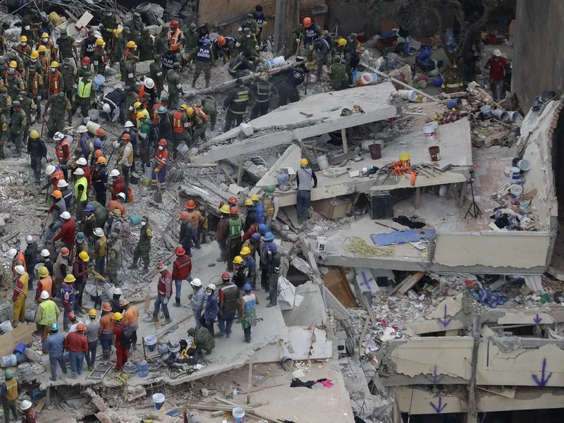 Rescue workers search for survivors among the rubble of a collapsed building in Mexico City. Structures throughout the capital were devastated during yesterday's earthquake. (Associated Press)