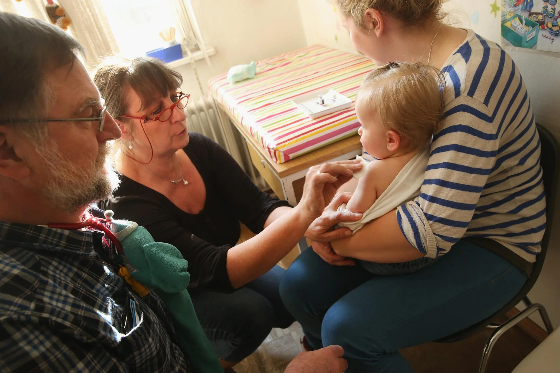 A doctor's assistant prepares 11-month-old Tijana for a vaccine against measles, rubella, mumps, and chicken pox in Berlin, Germany, in 2015. PHOTOGRAPH BY SEAN GALLUP, GETTY