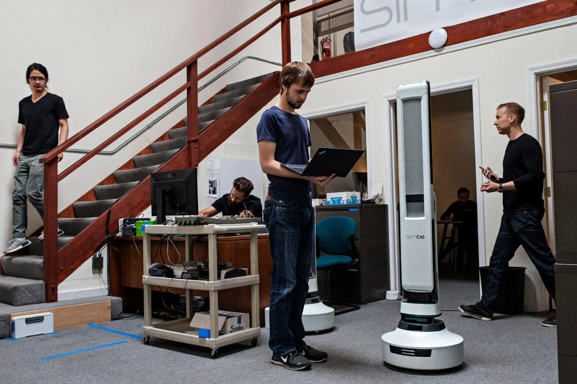Senior robotics engineer Steven Macenski works on robot perception with the Tally robot, which is designed to scan shelves to identify objects that are misplaced, priced incorrectly, low in stock, or out of stock. PHOTOGRAPH BY LAURA MORTON