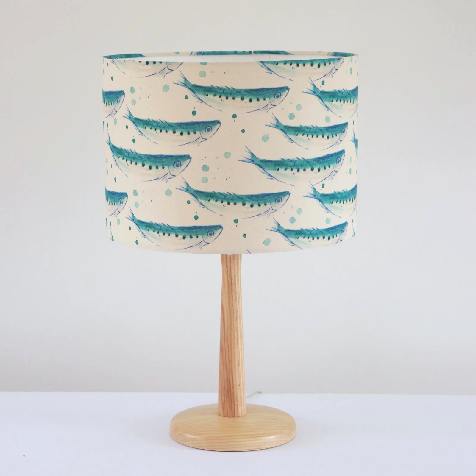 ISwimming sardines illustrated organic lampshade handmade in Cornwall with playful coastal fish design printed on natural fabric..png