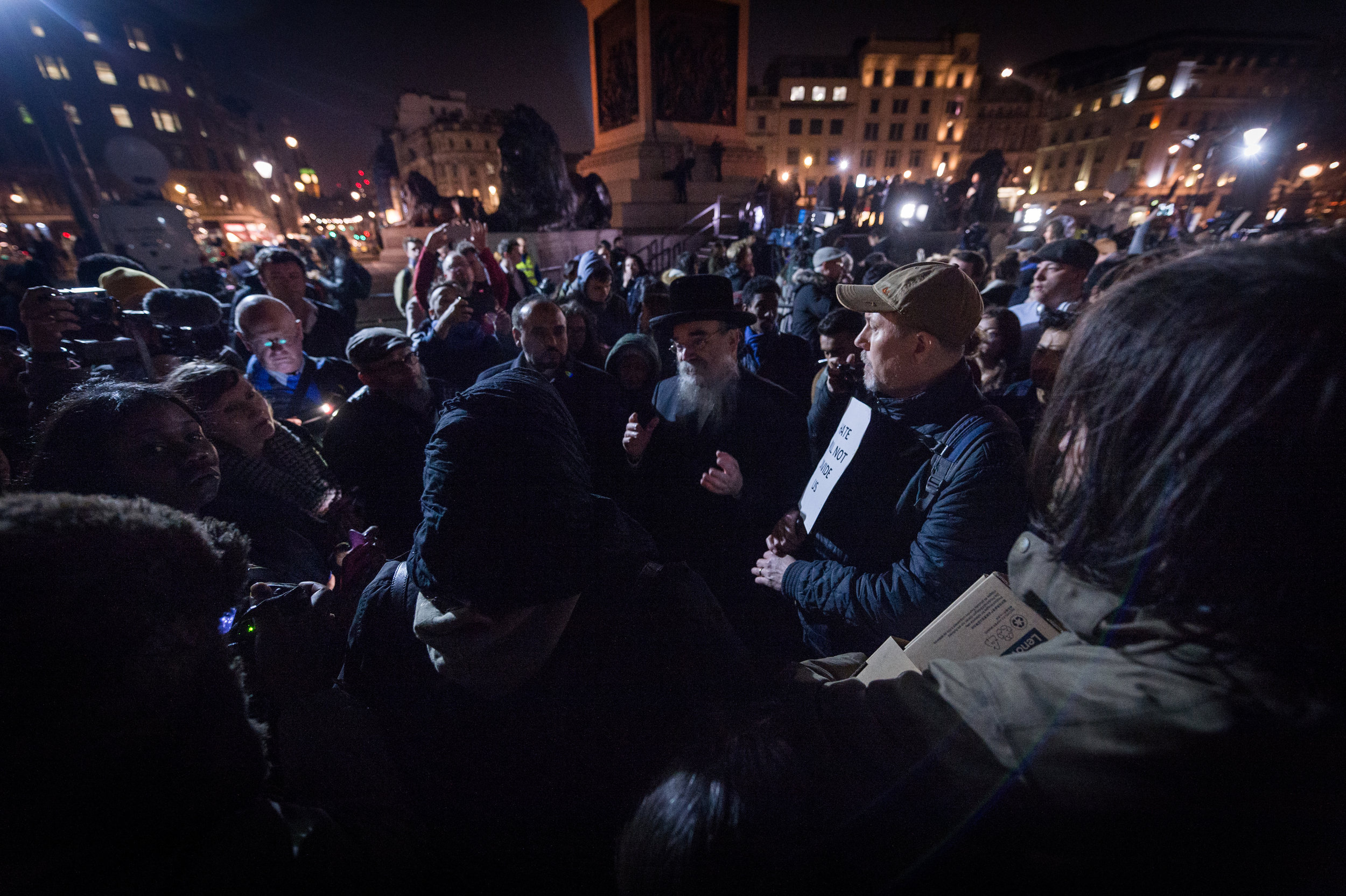  Crowds gather around a Rabbi and a Muslim woman as they engage in a public debate about how representatives of each religion can move forward from this tragedy. 